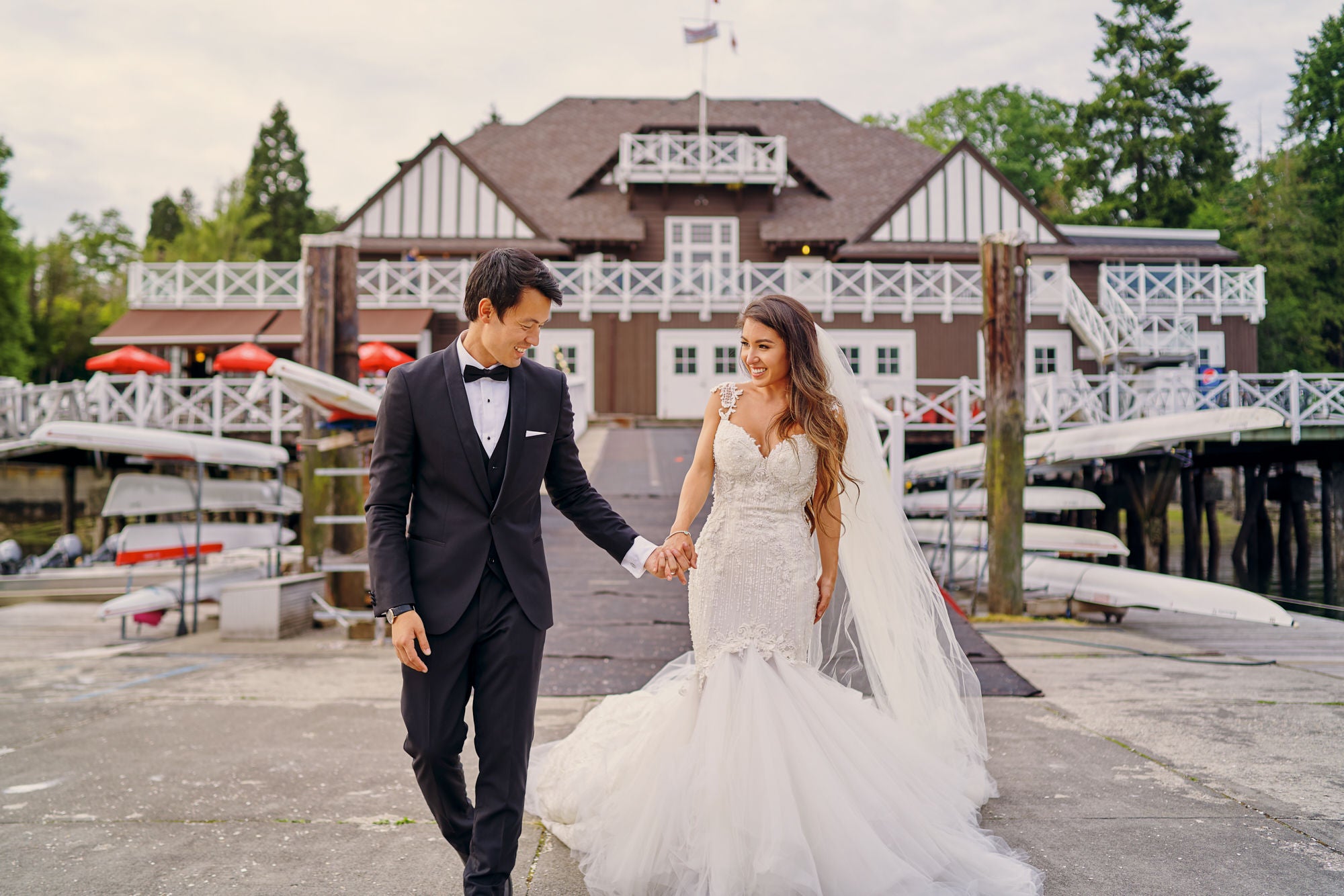 GL Bride Anita wearing our Ms. Elle gown walking wit her husband