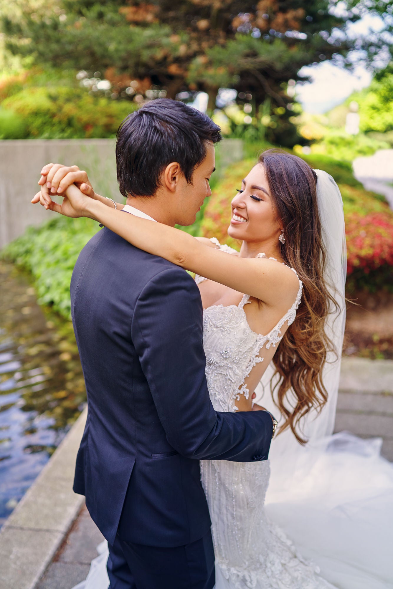 GL Bride Anita wearing our Ms. Elle gown embracing her husband