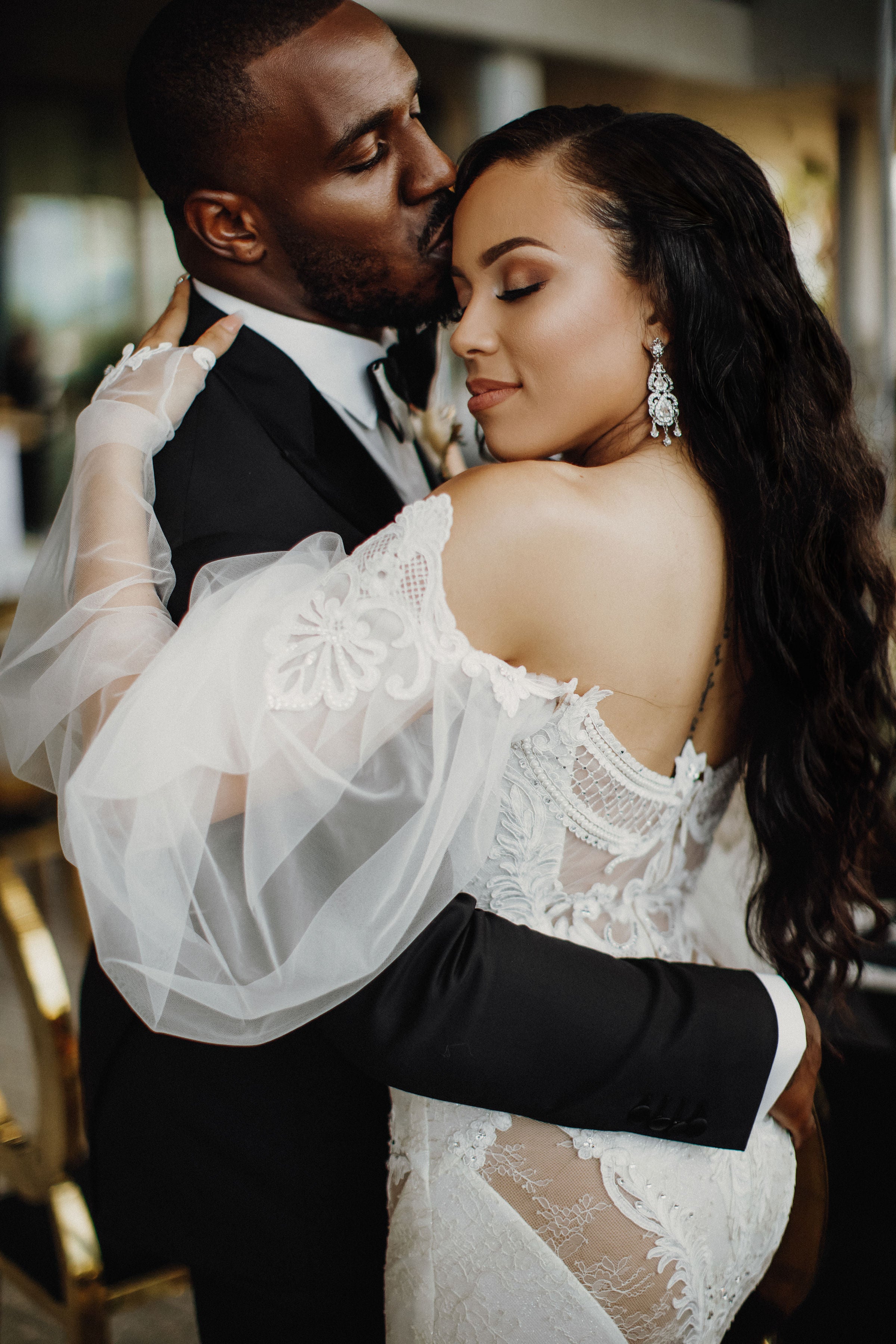 The couple embracing with our GL Bride wearing the Thelma gown