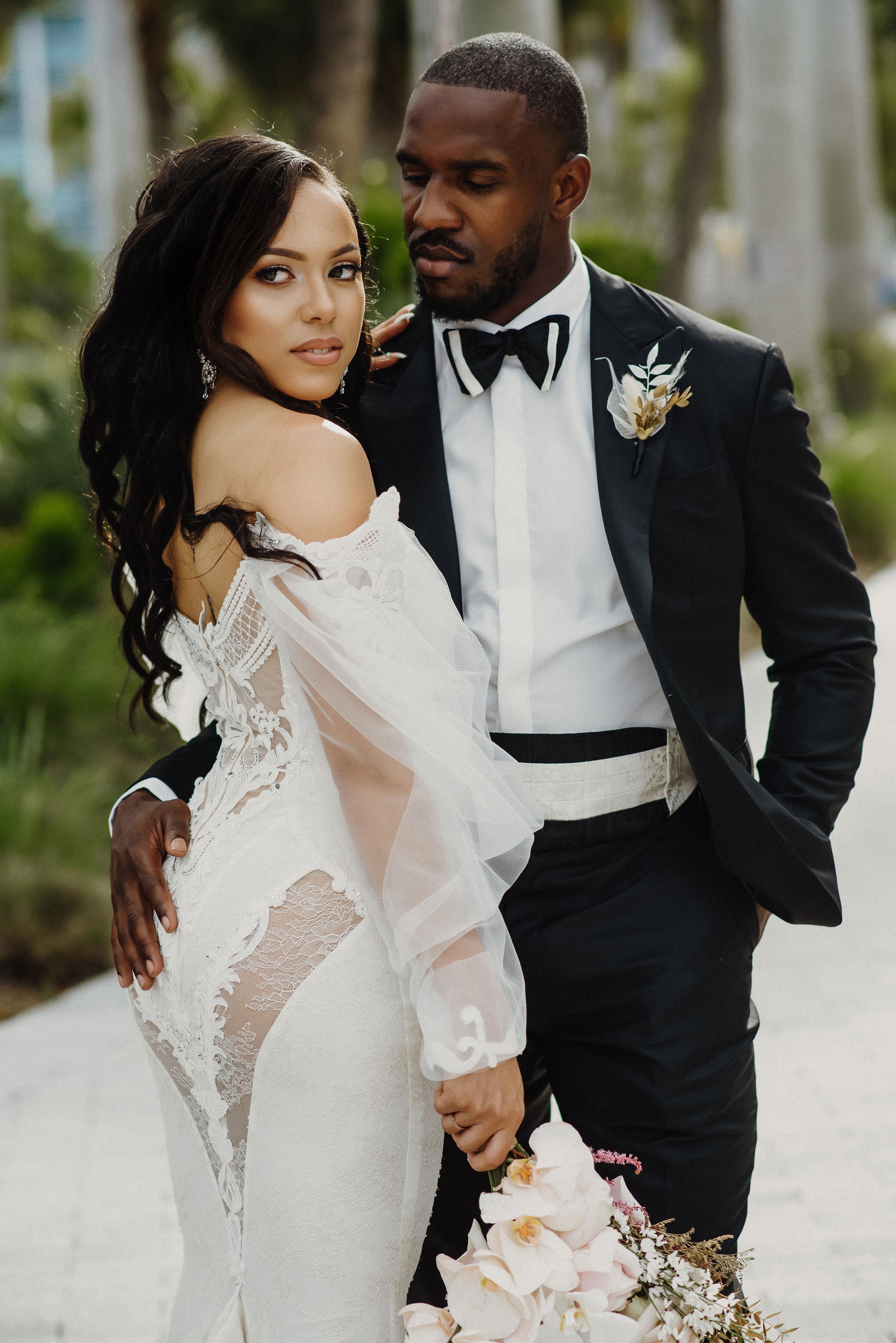 The couple embracing with the bride wearing our Thelma gown