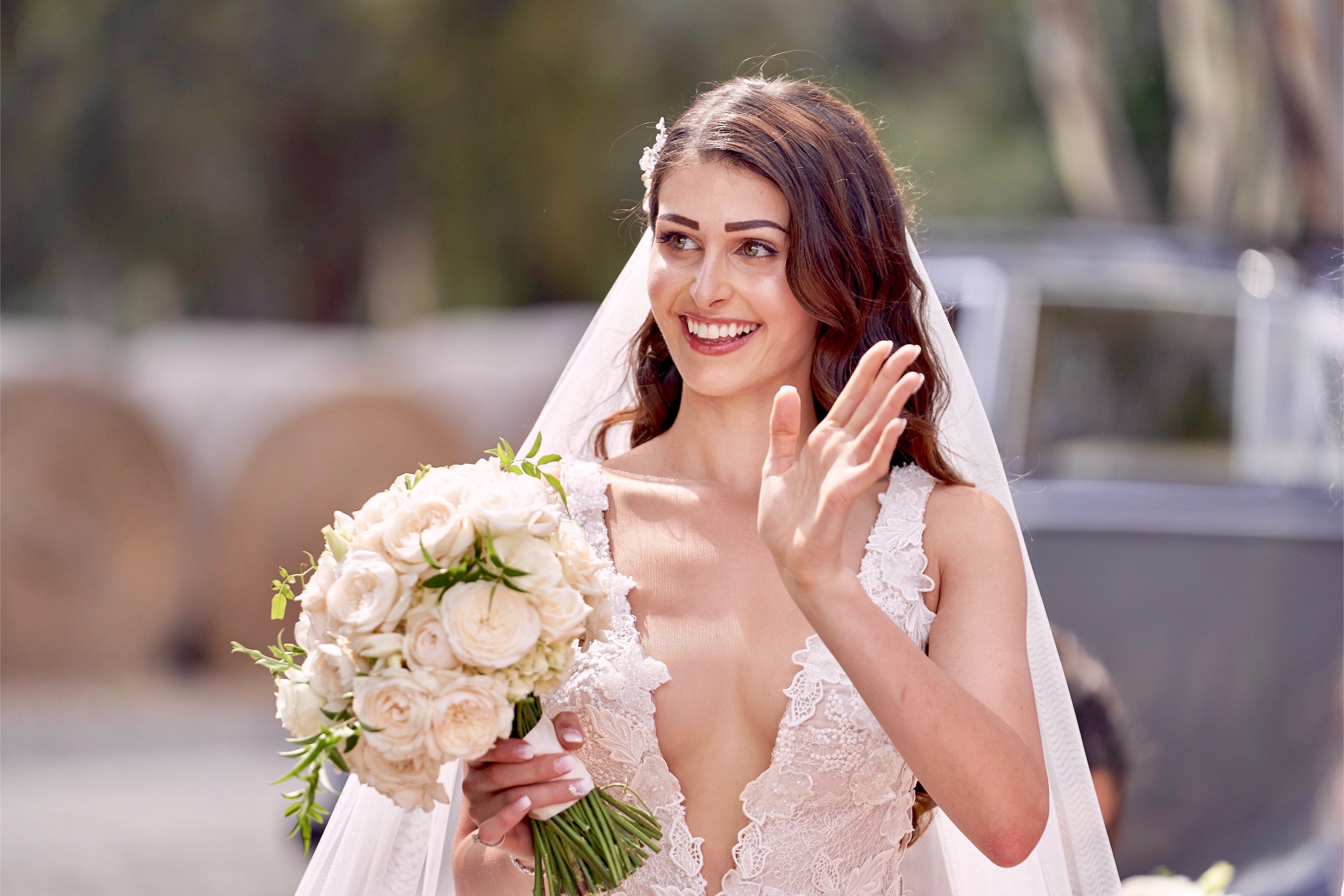 GL Bride Nadia waving with her floral bouquet