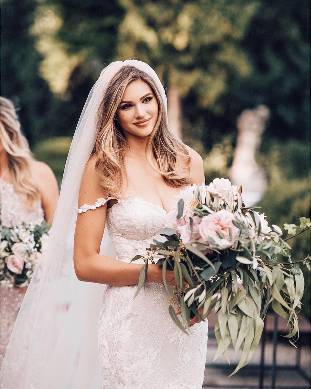 GL Bride Natalie in our Tony gown holding her floral bouquet