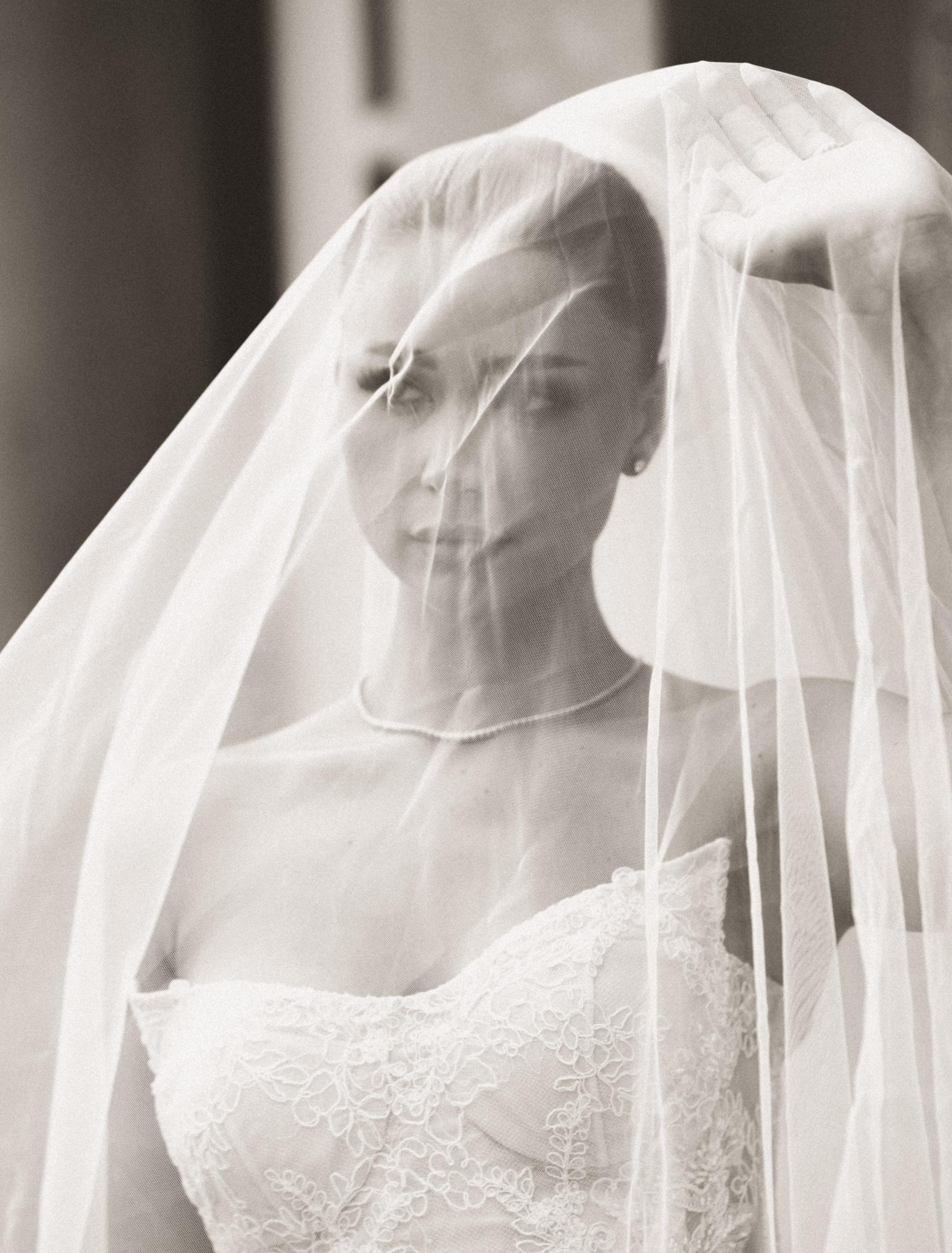 Black and white photo of a bride wearing a veil