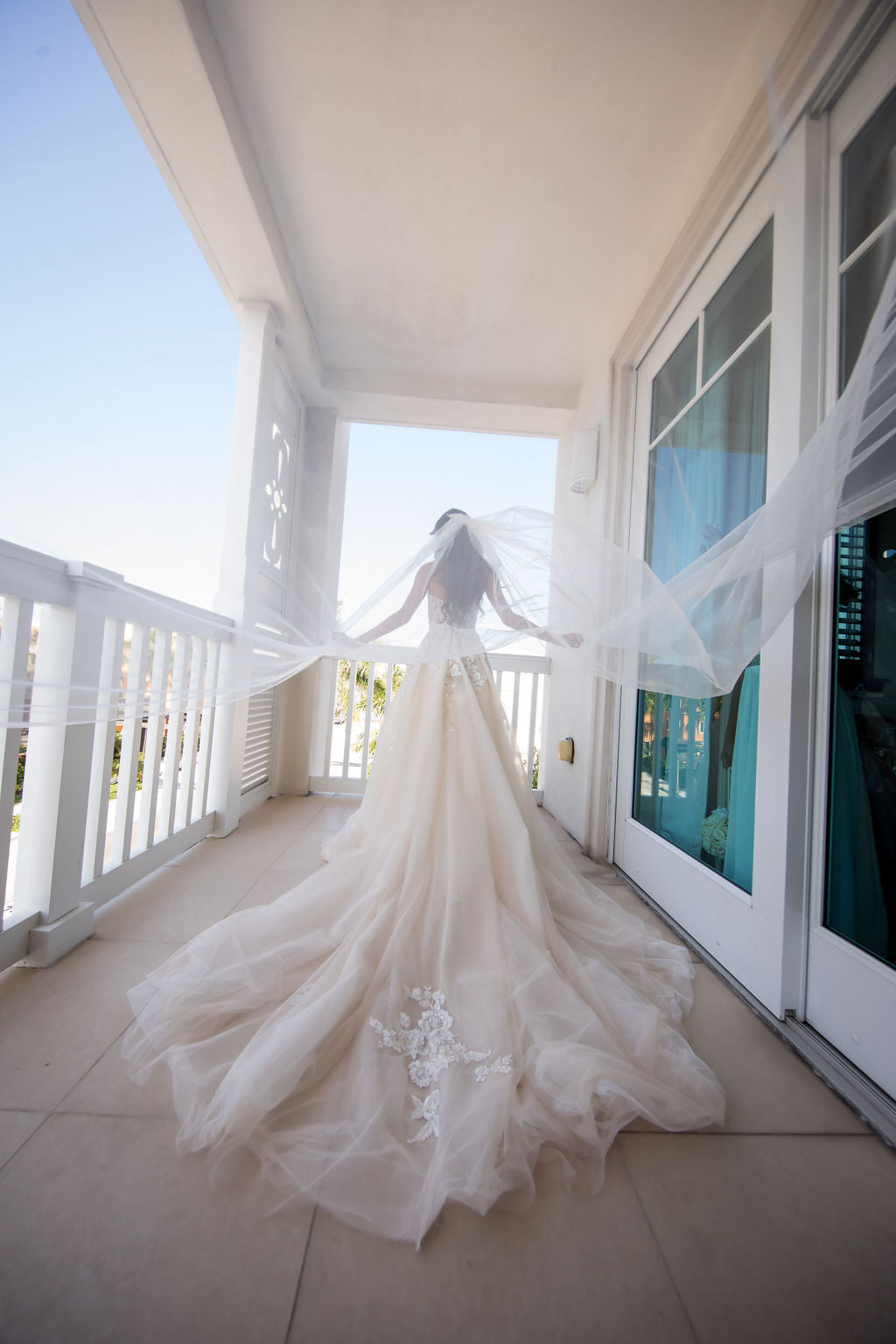 GL Bride Sam in our Gia Gown with her veil blowing in the wind