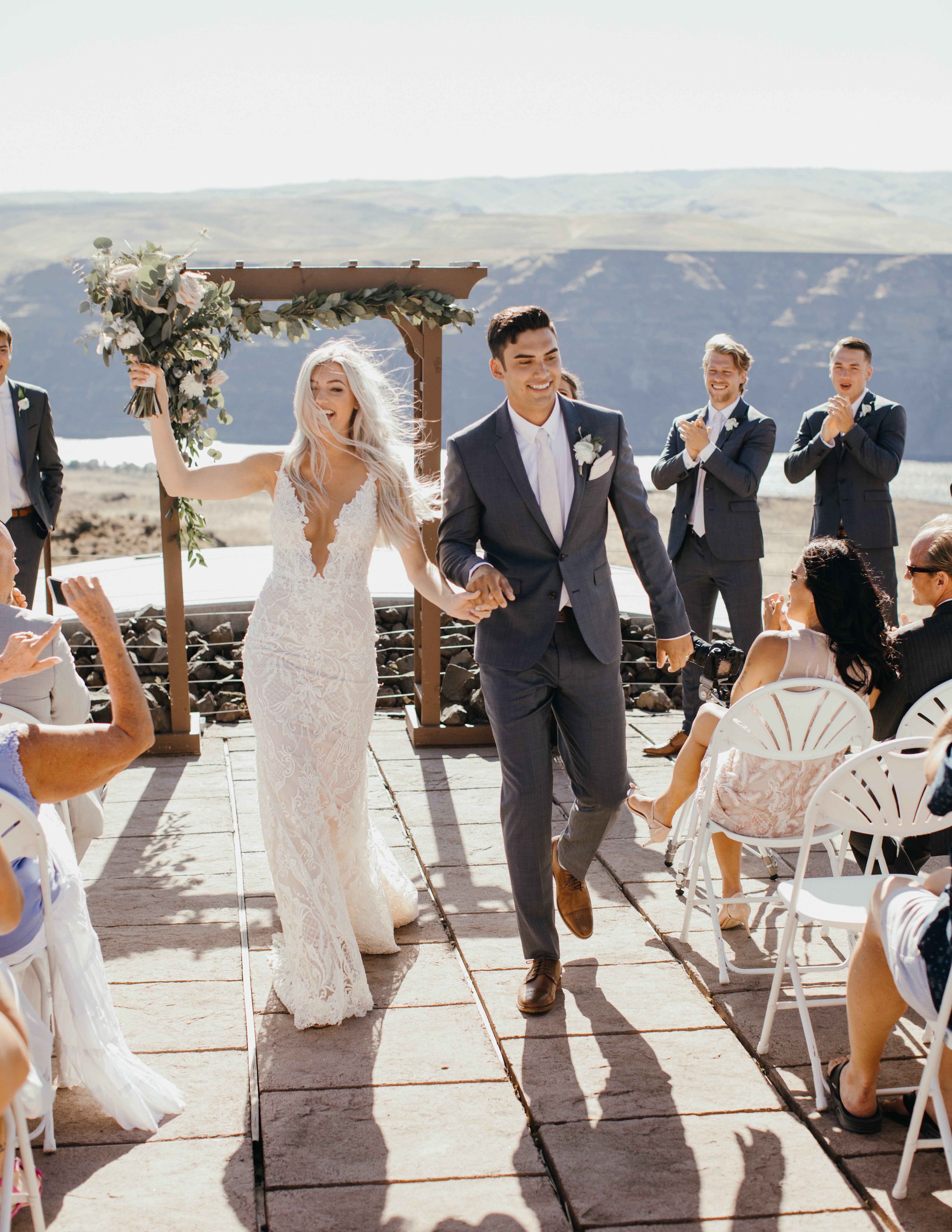 GL Bride Taina wearing the GALA 708 walking down the aisle with her husband