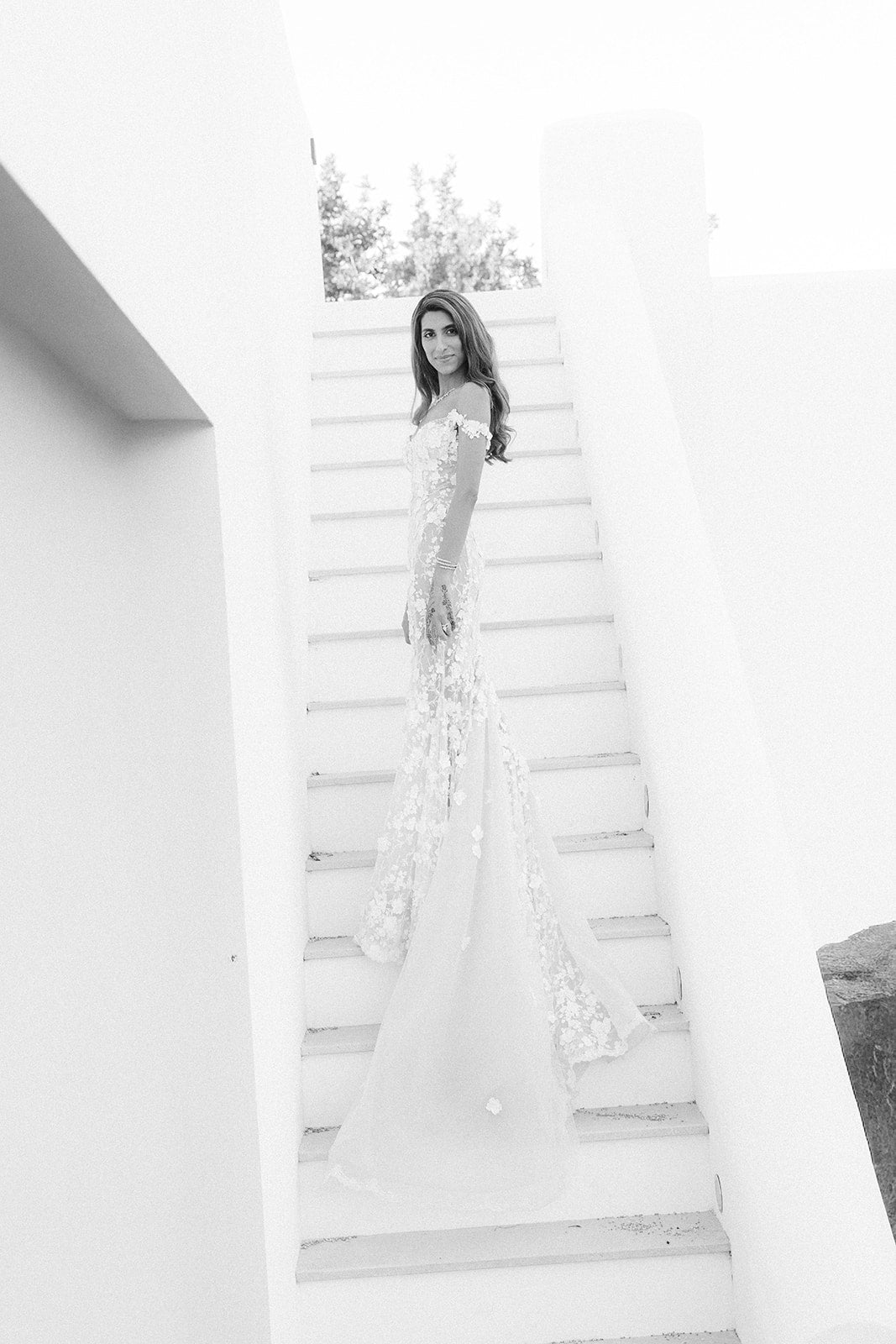 GL Bride Tara in our Maya gown standing on a staircase
