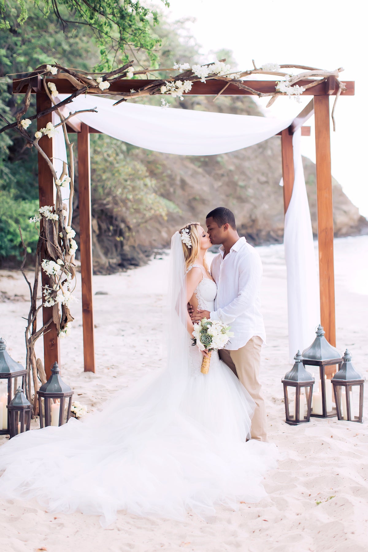 GL Bride Allie wearing our Loretta gown at the altar with her husband