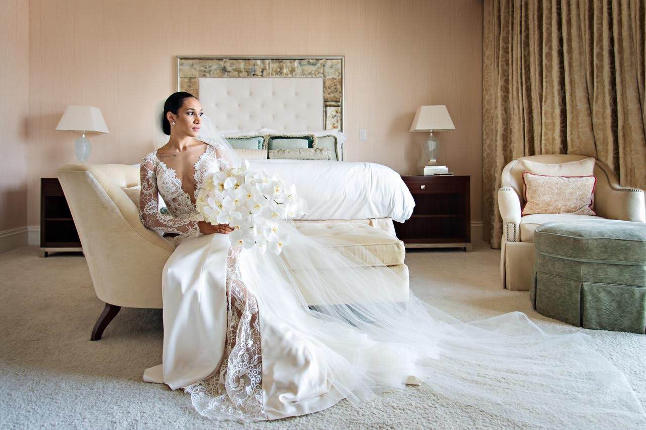 GL Bride Of The Week McKenzie wwaring our Tiger Lily dress sitting in a hotel room