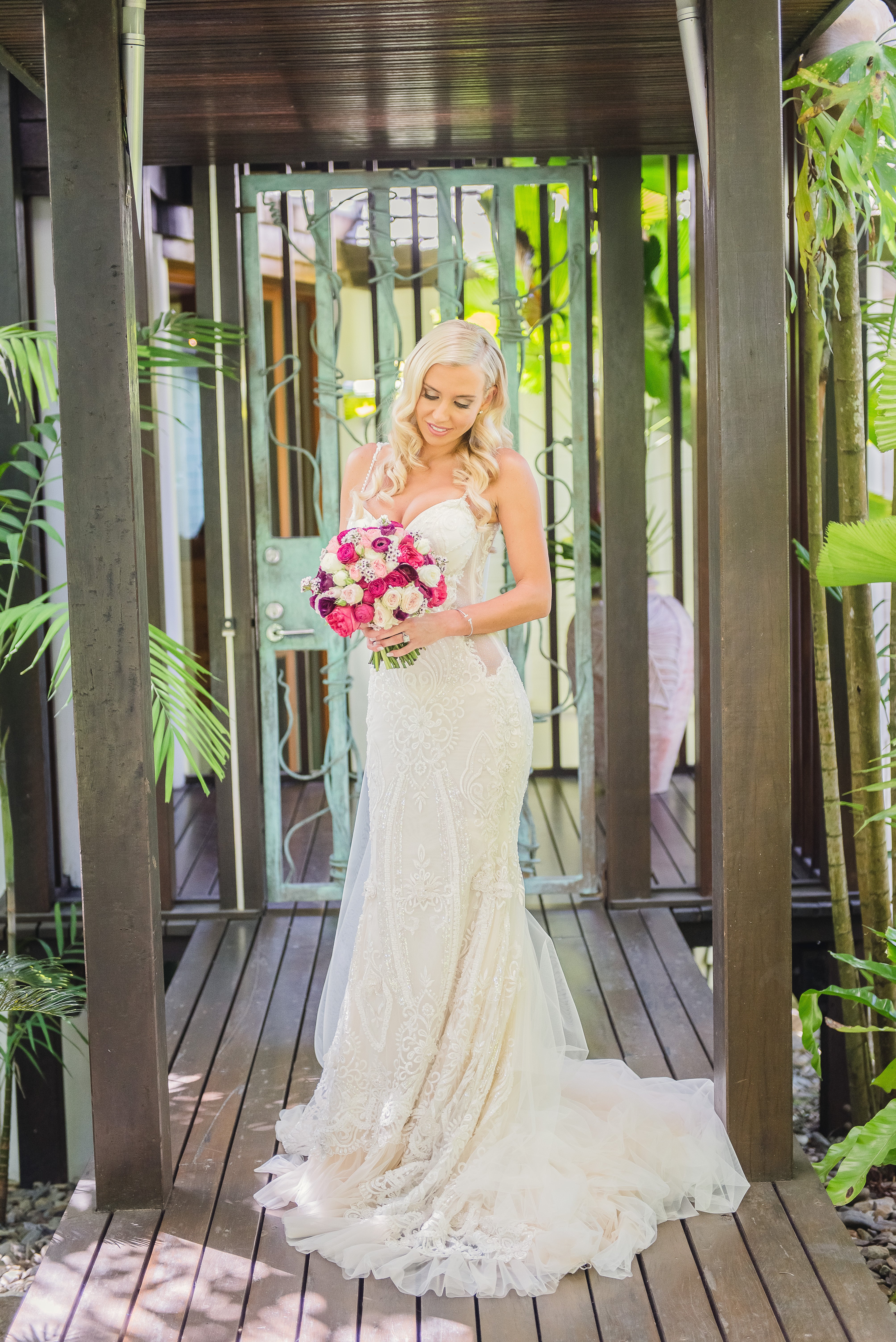 GL Bride Elise wearing our Greta Garbo standing with her floral bouquet