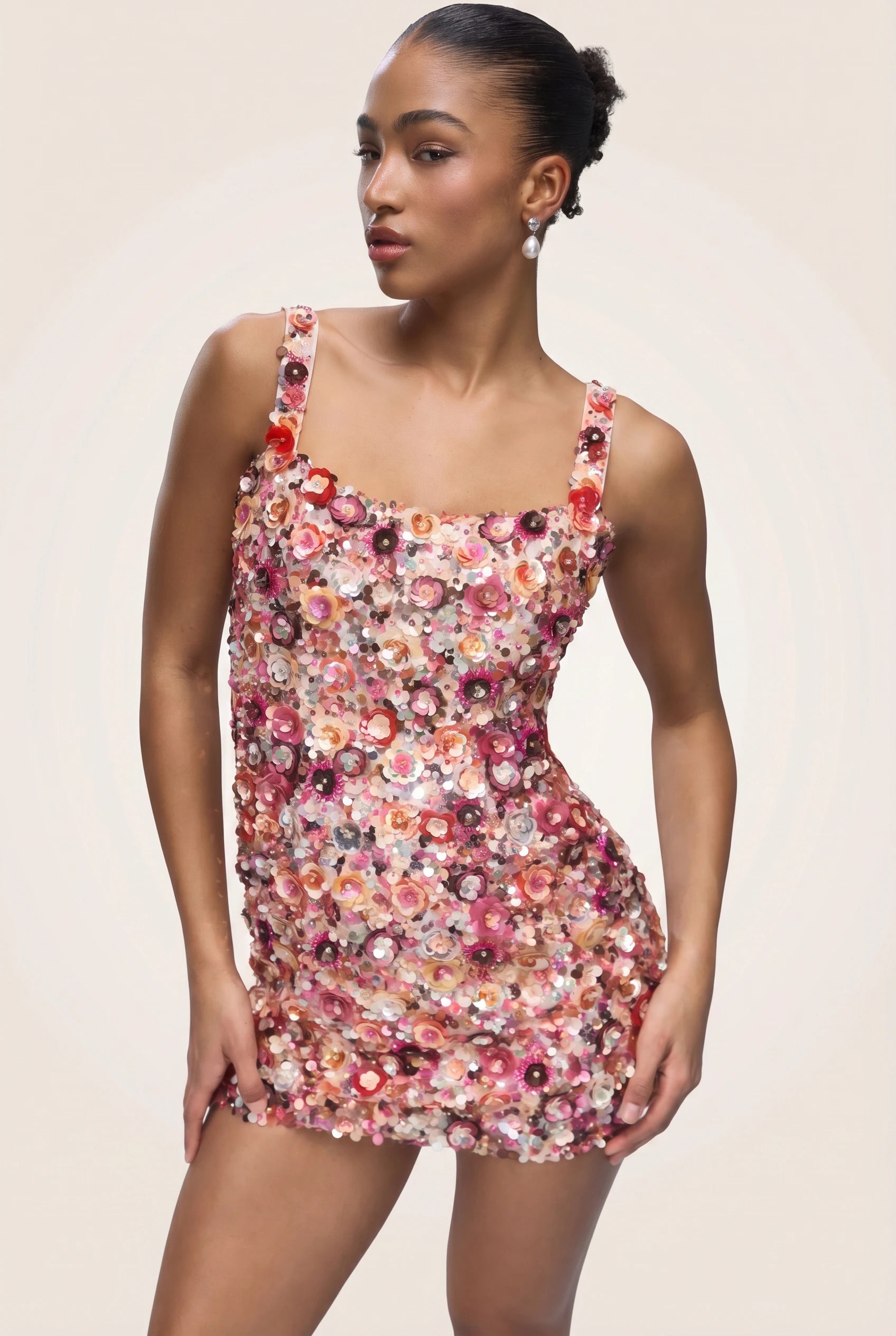 Woman wearing a floral dress against a plain background