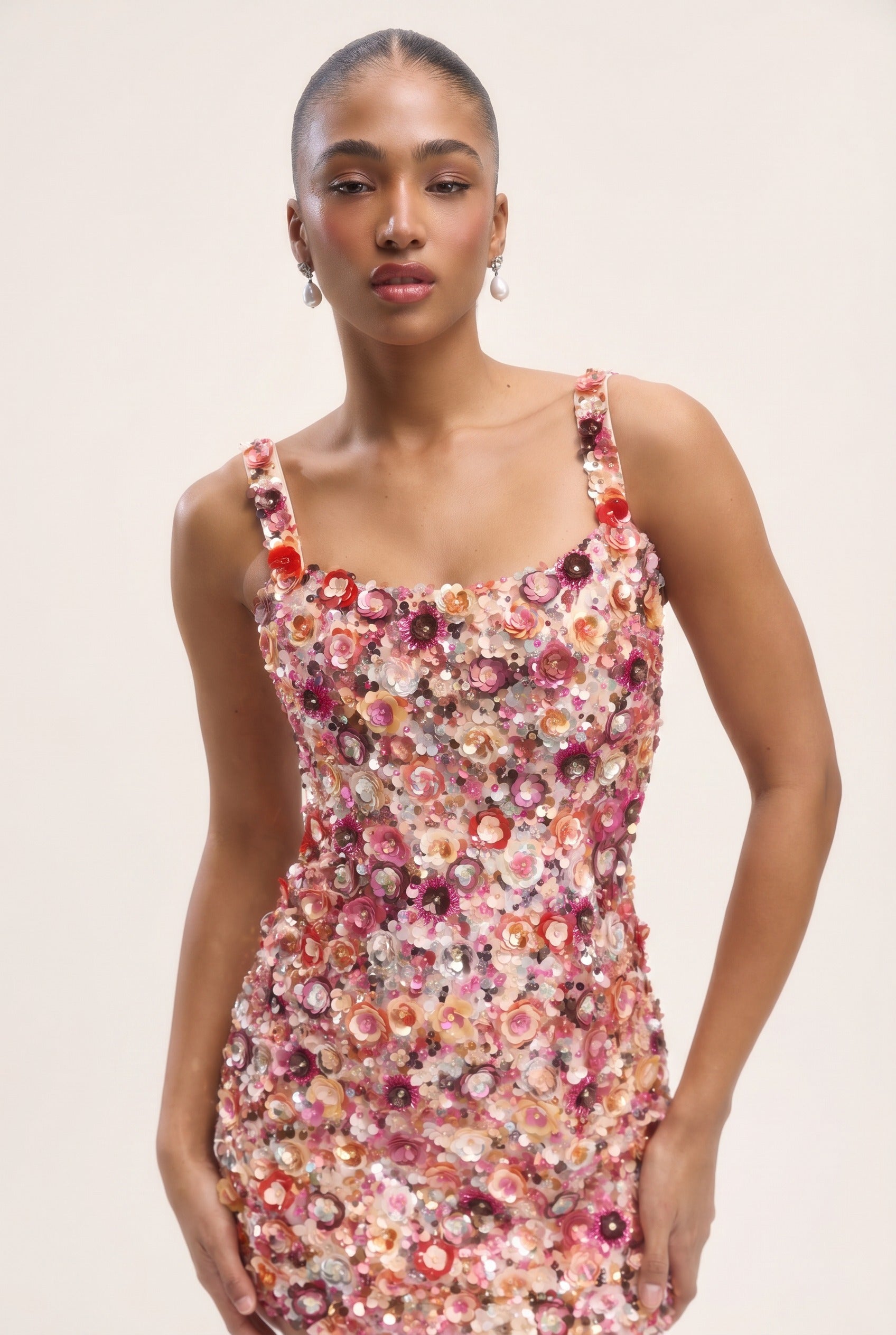Woman wearing a floral dress against a plain background