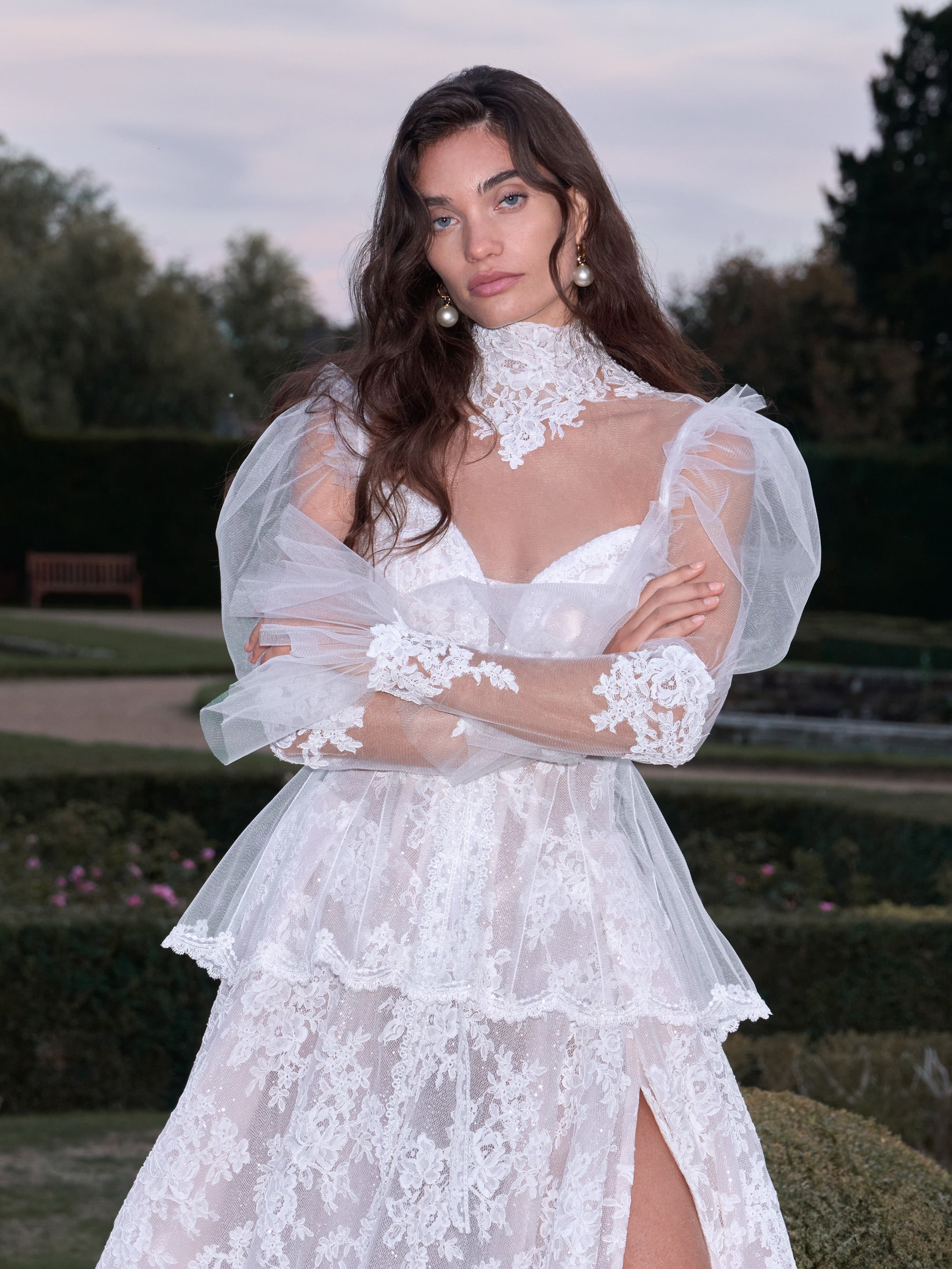 Woman wearing a white lace dress in an outdoor setting