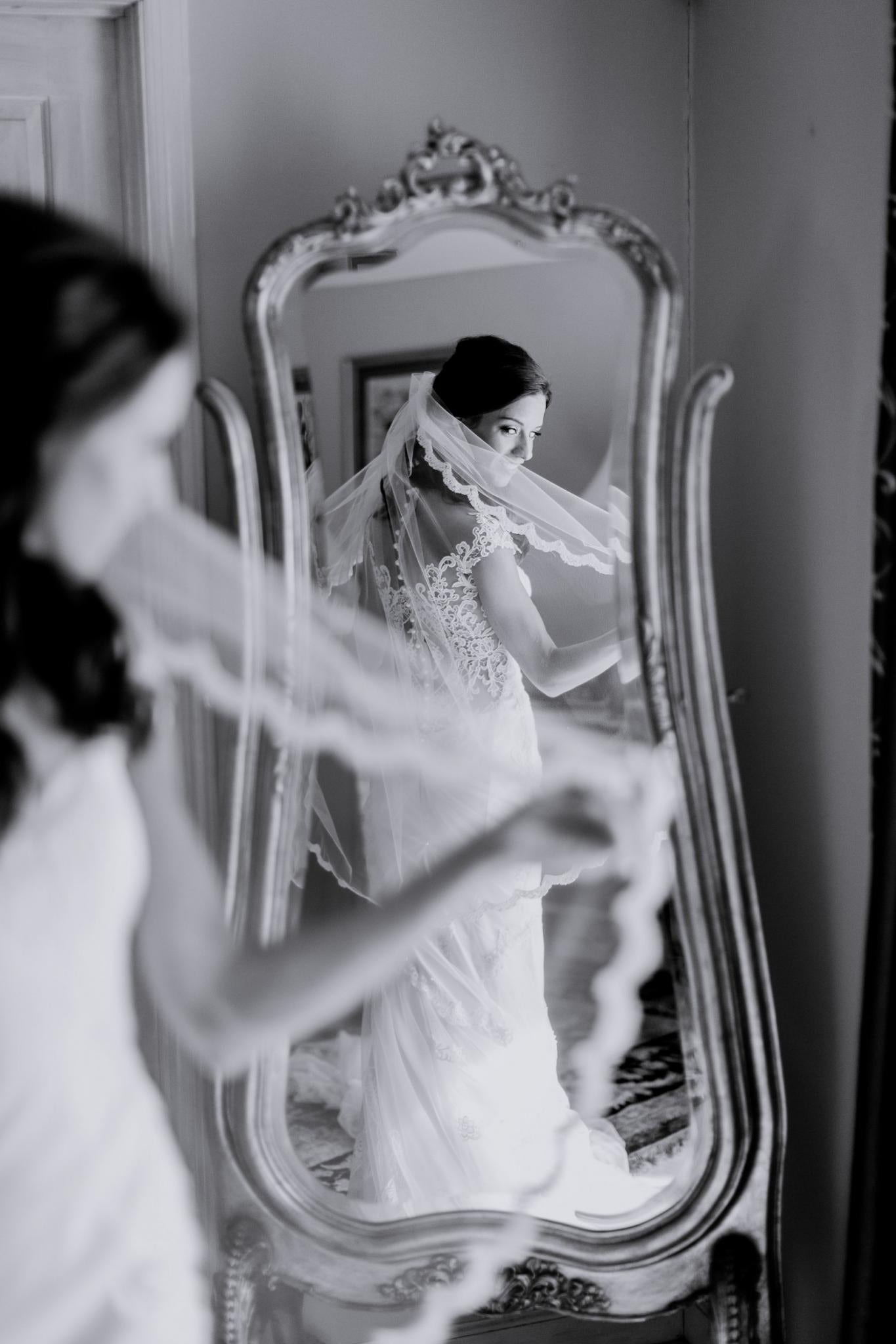 GL Bride Jennifer wearing the Fiona looking at her reflection