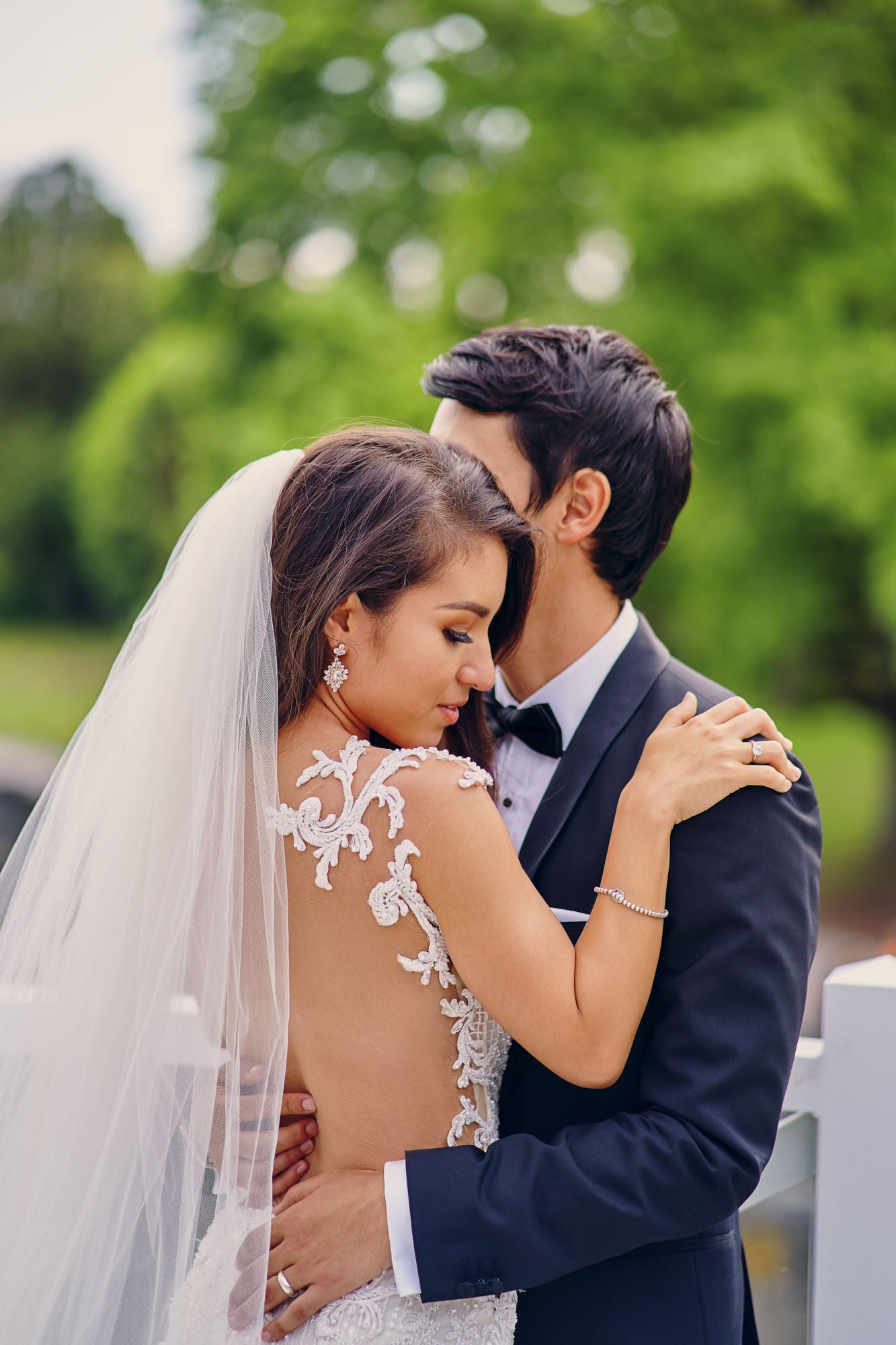 GL Bride Anita wearing our Ms. Elle being embraced by her husband 