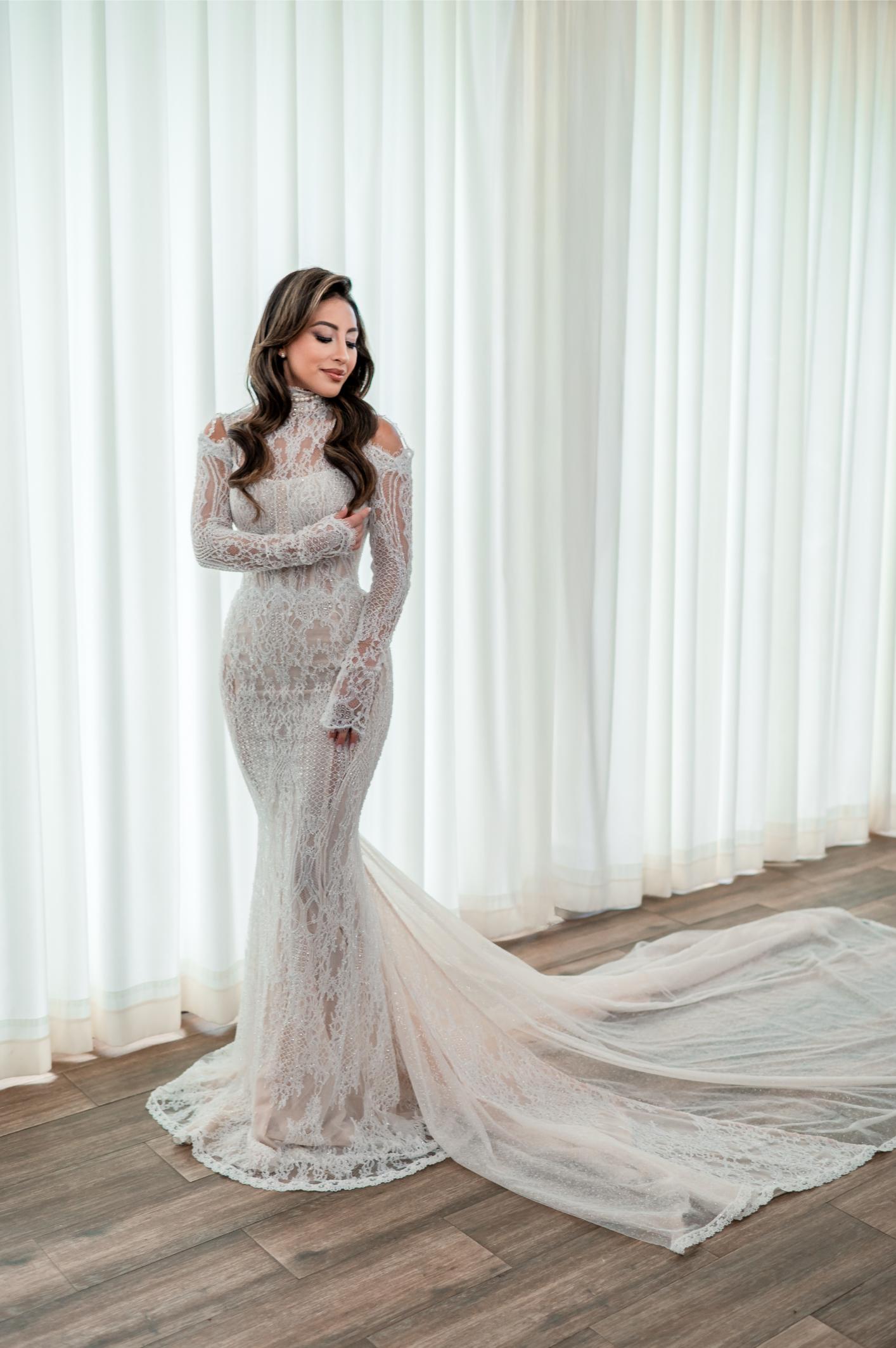 GL Bride Betty Luna in our Élysée, standing in front of white curtains 