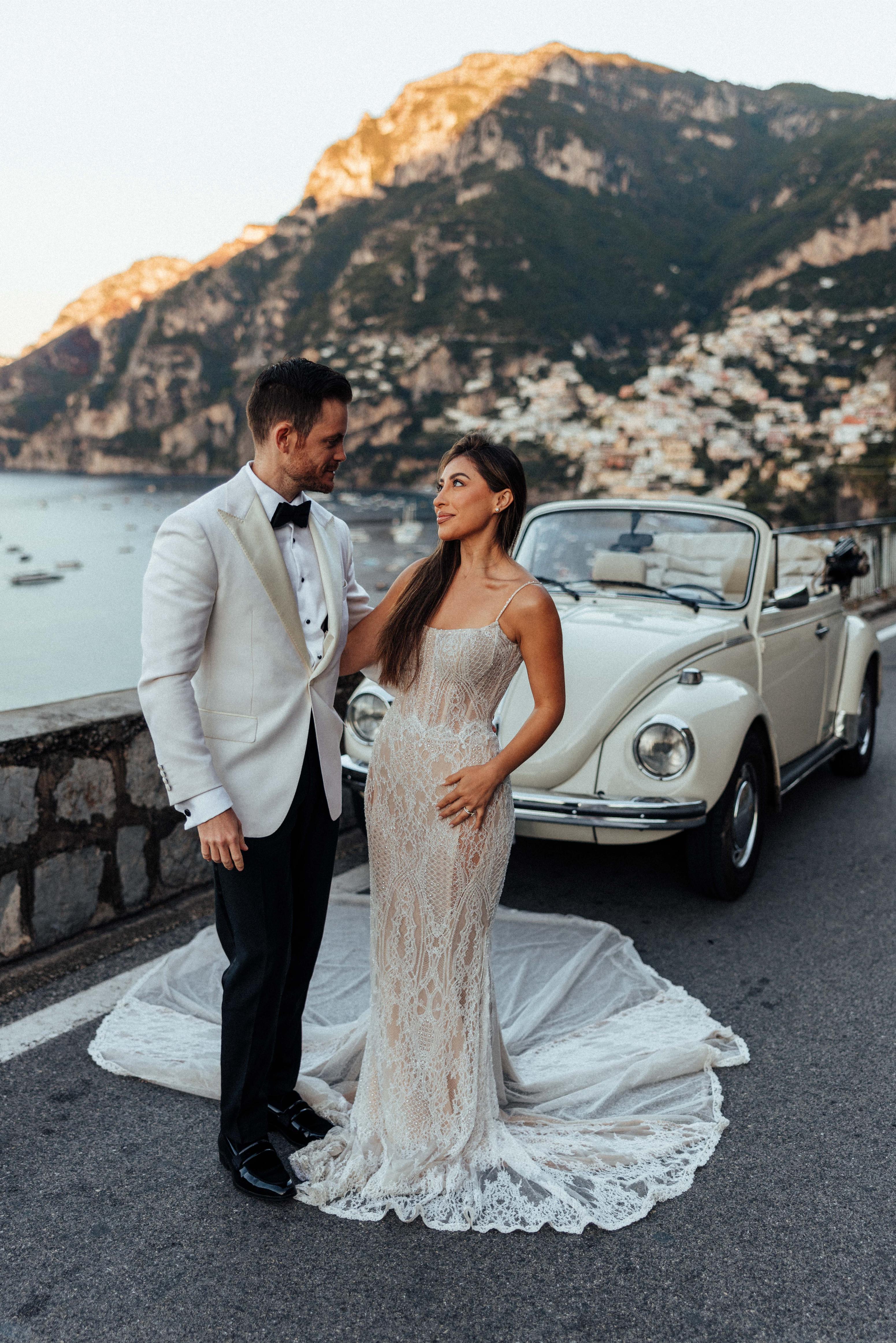 GL Bride Betty Luna in our Élysée  with her husband, in front of a vintage car 