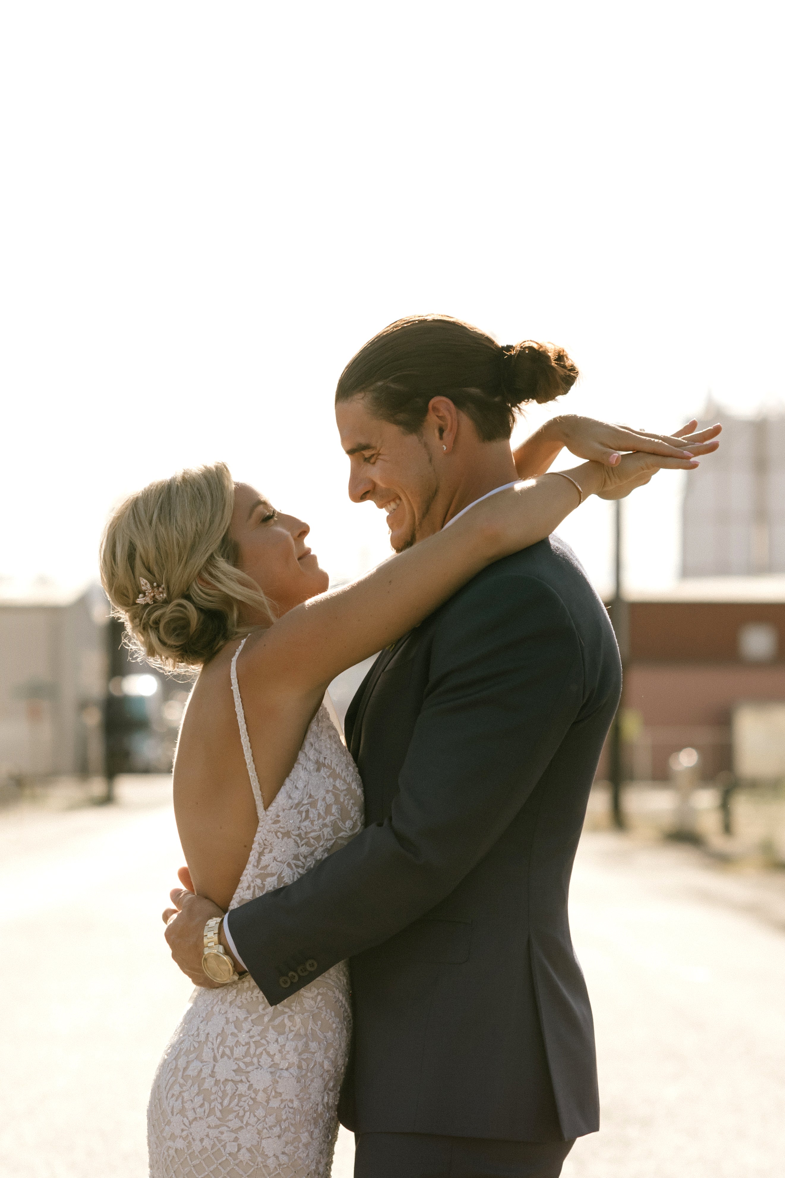 GL Bride Carly wearing our GALA 708 embracing her husband 