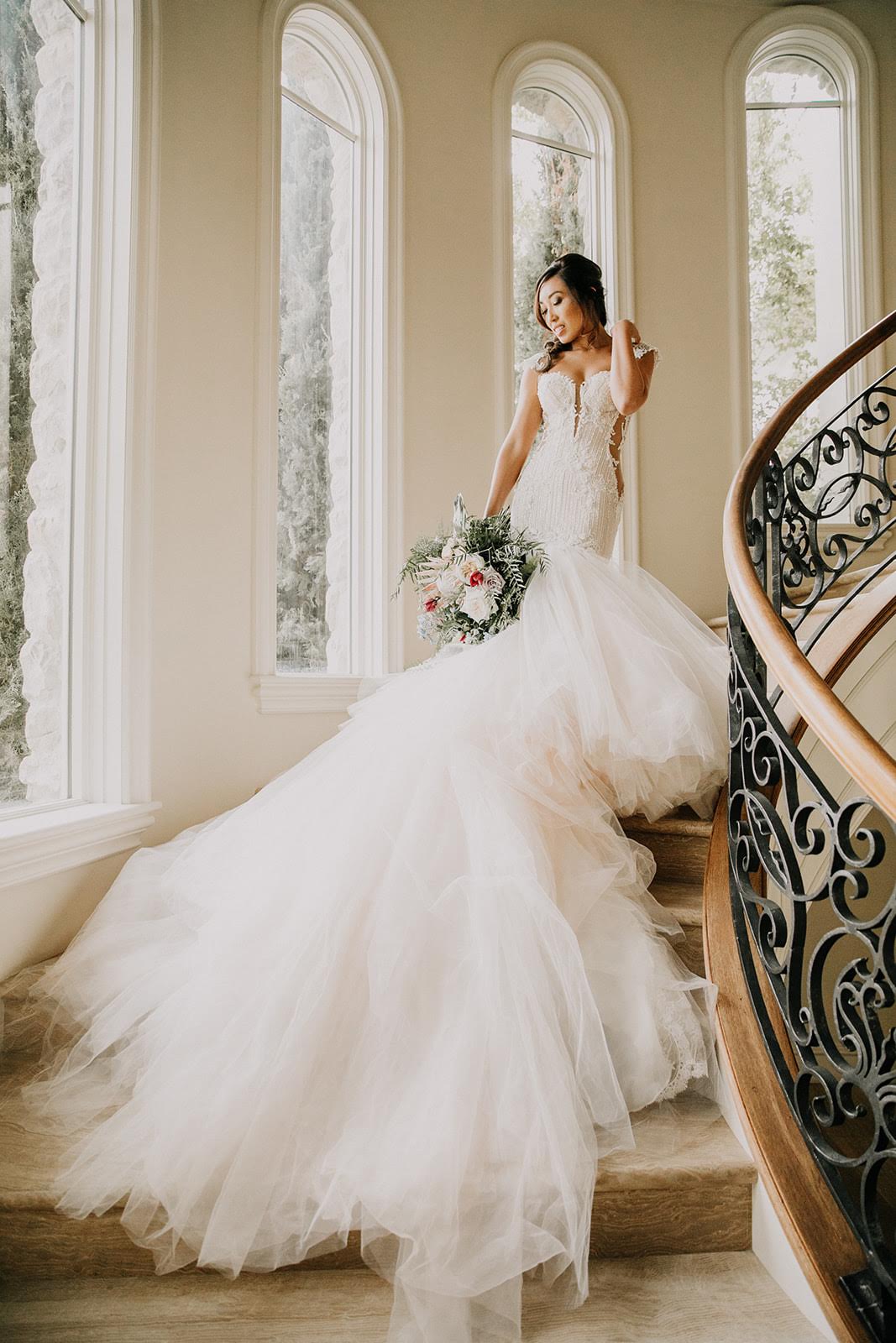 GL Bride Cassey Ho wearing Galia Lahav Ms. Elle standing on stairs with her bouquet 
