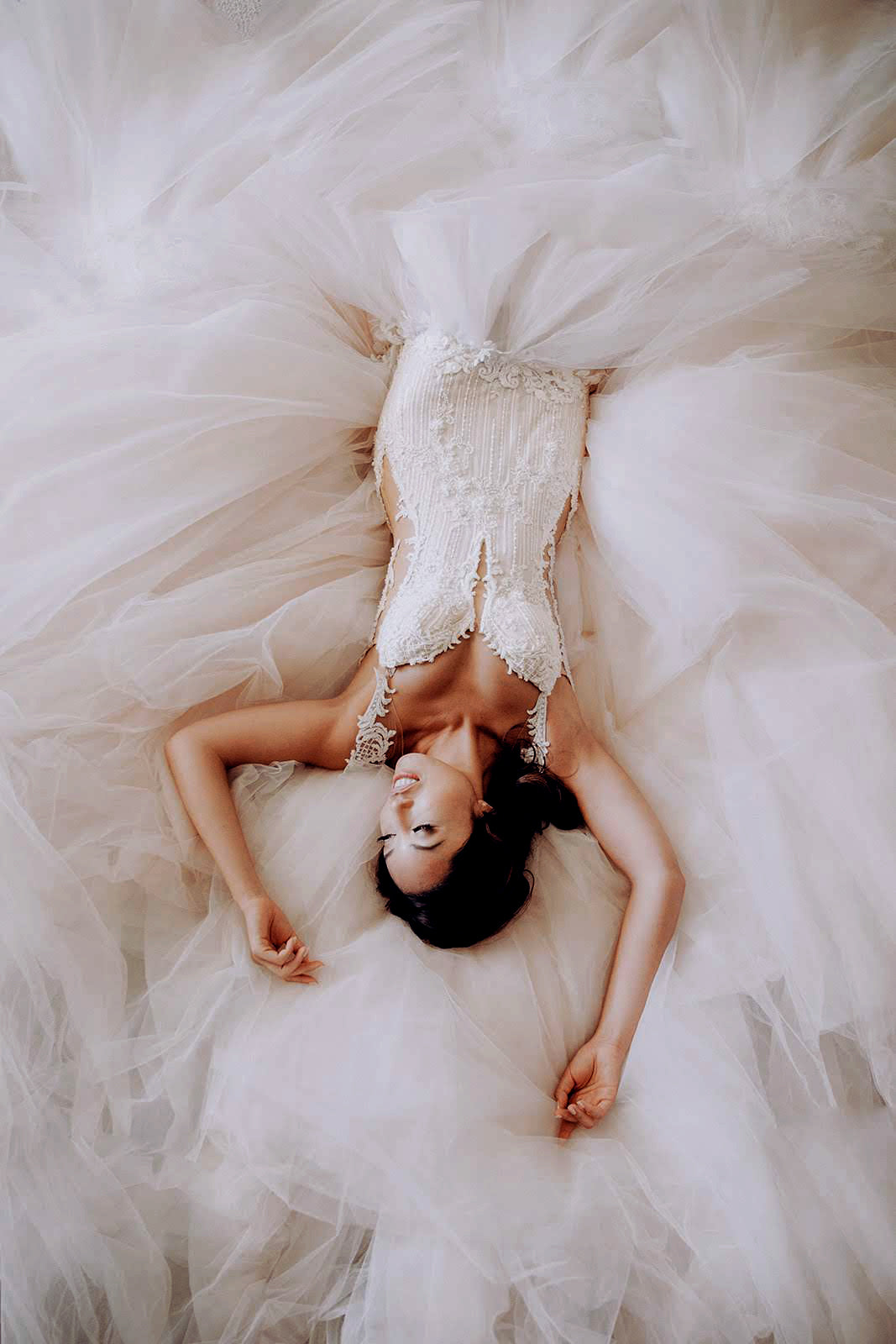 GL Bride Cassey Ho wearing Galia Lahav Ms. Elle laying down