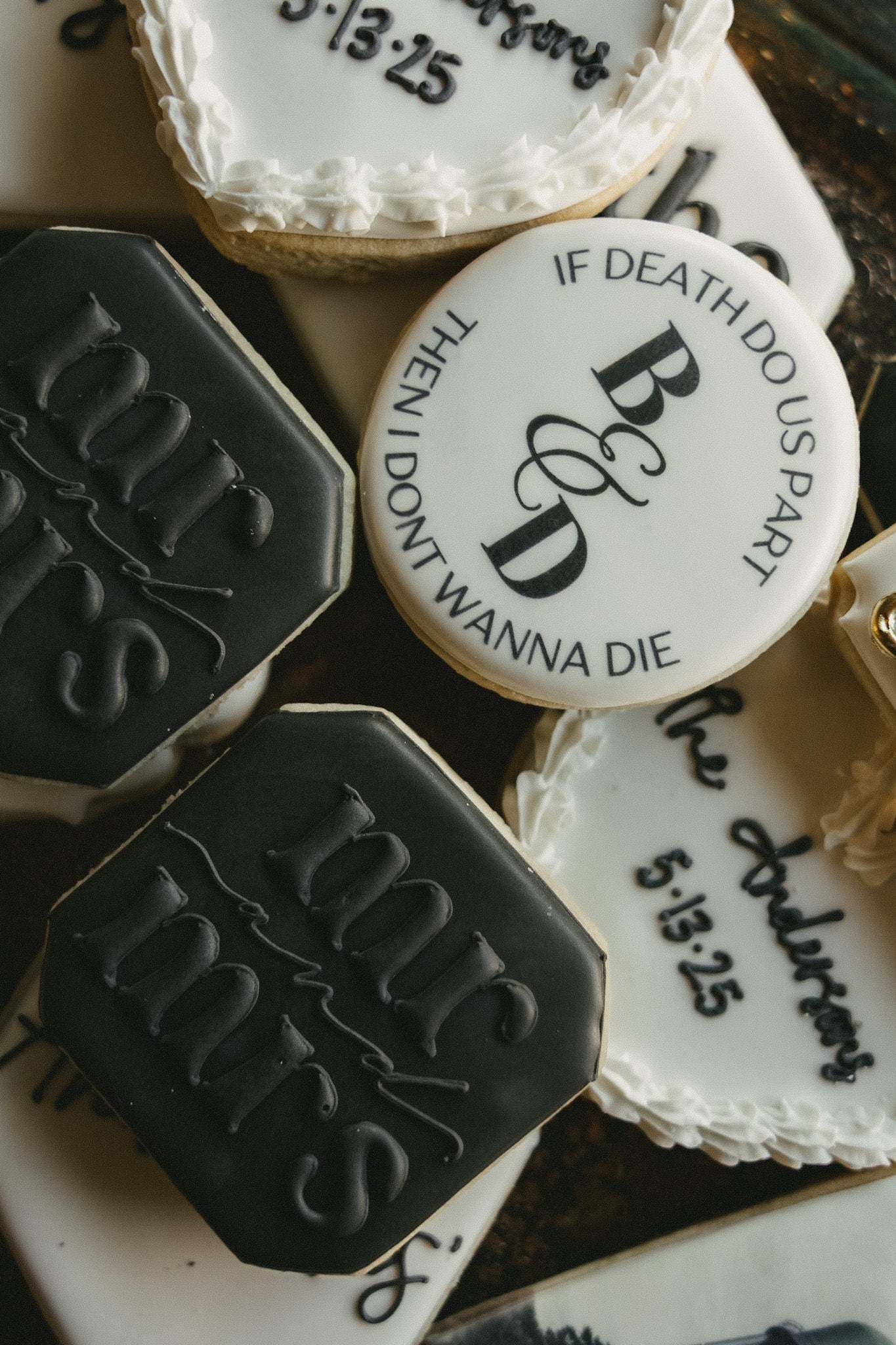 Decorative cookies with text and monogram on a white surface