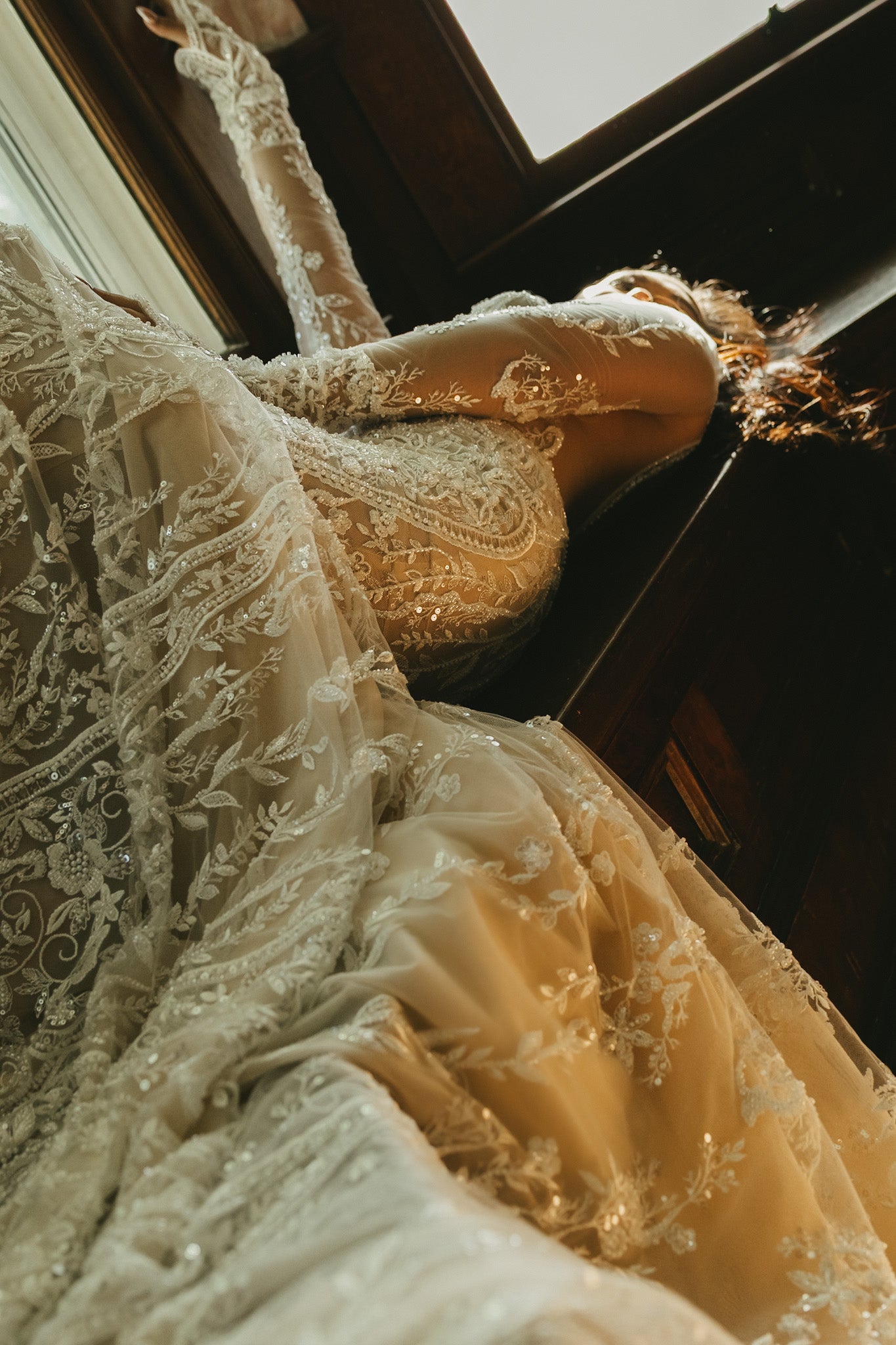 Close-up of a person wearing a lace dress with intricate detailing.