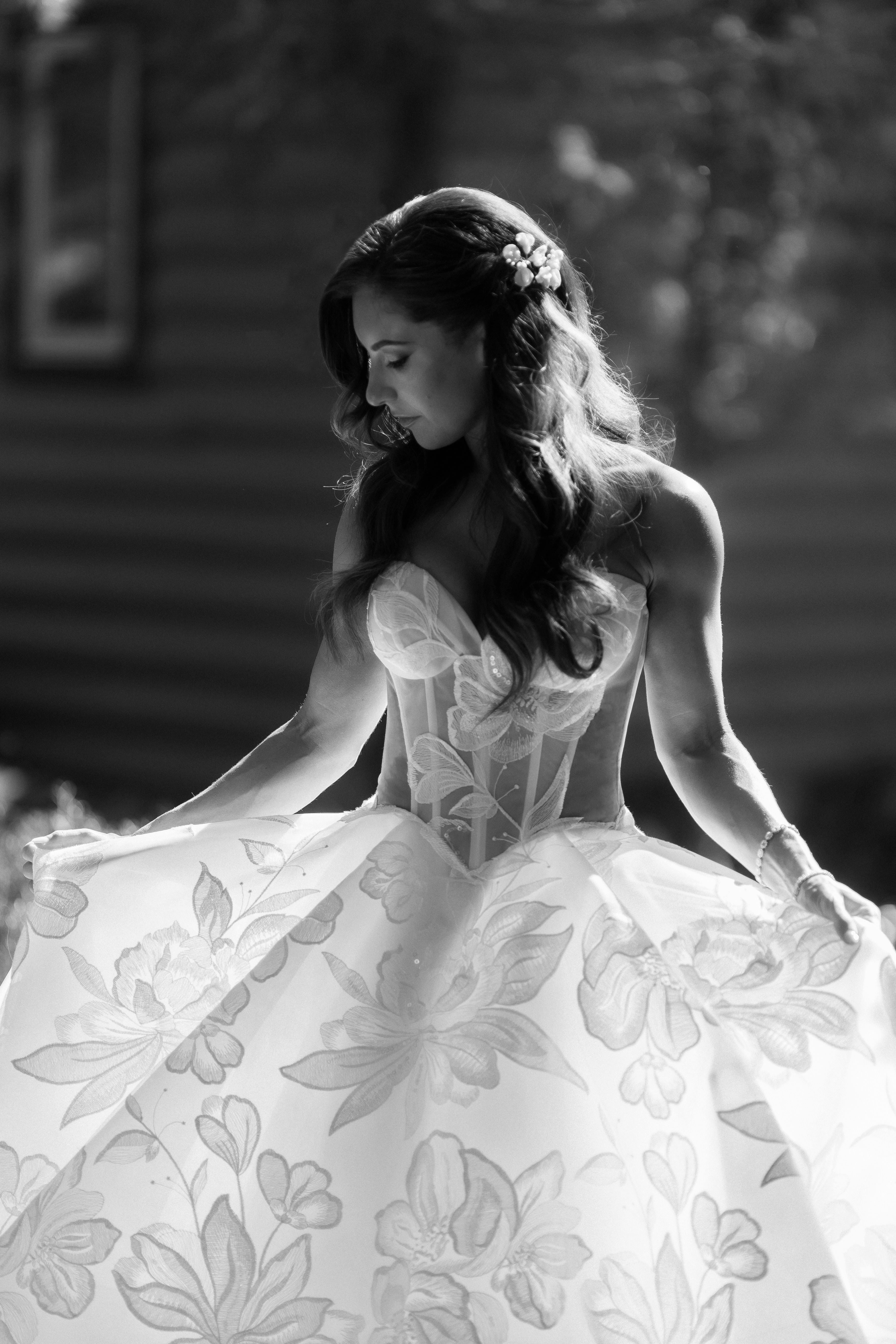 Woman in our Evelyn wedding dress with a blurred background