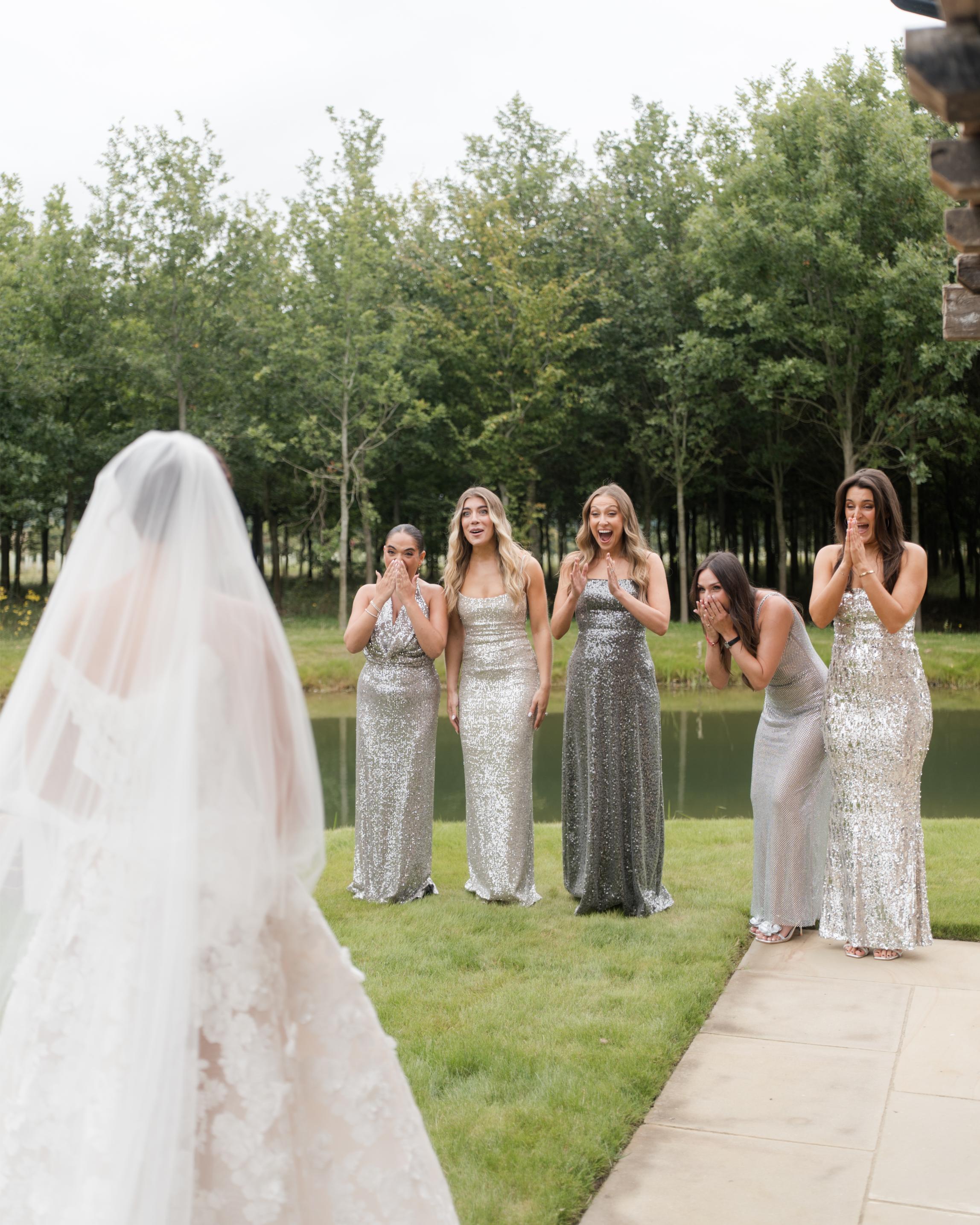 GL Bride Emily in our Rosemary with bridesmaids in silver sequin dresses outdoors.