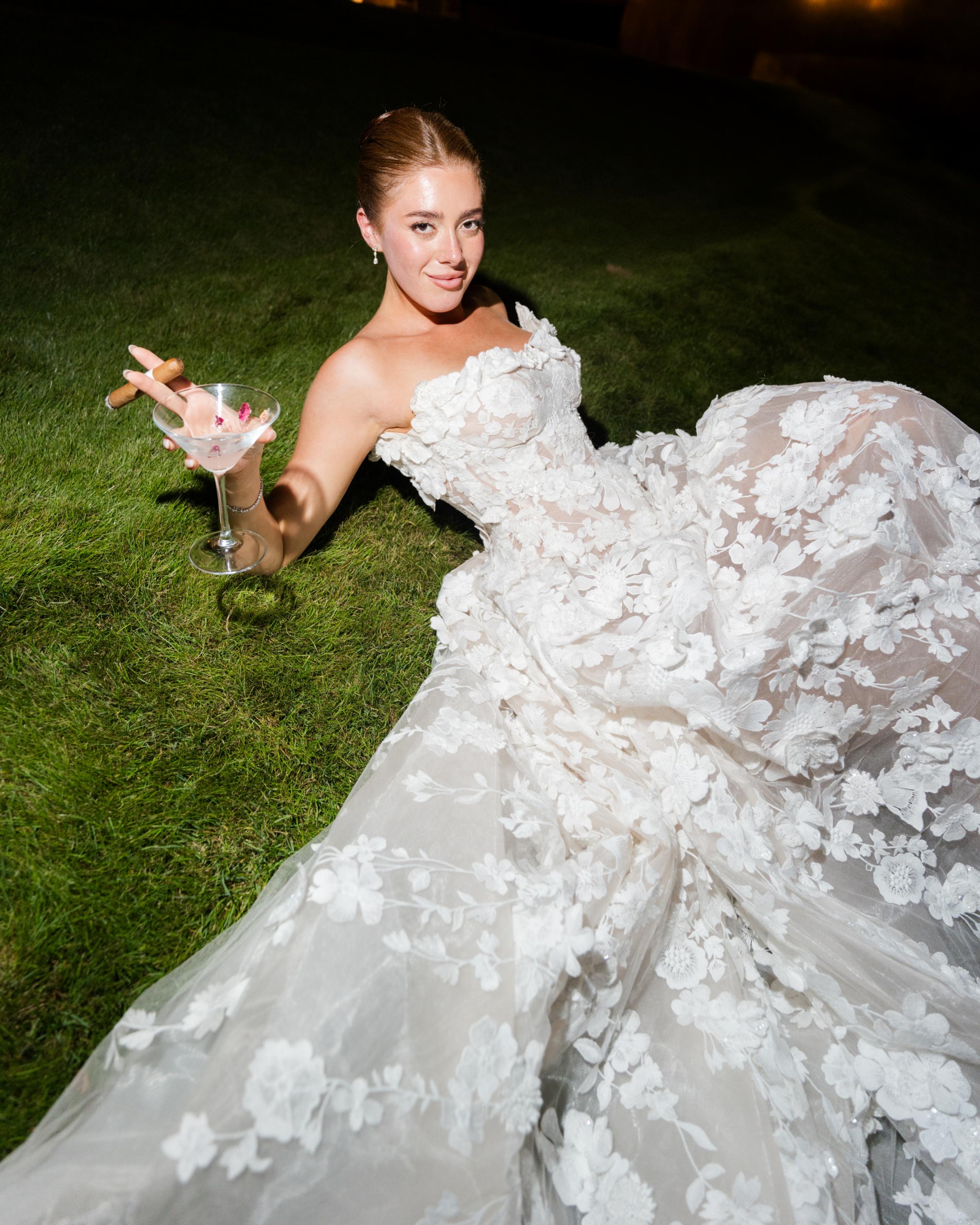 GL Bride Emily in our Rosemary holding a glass on grass