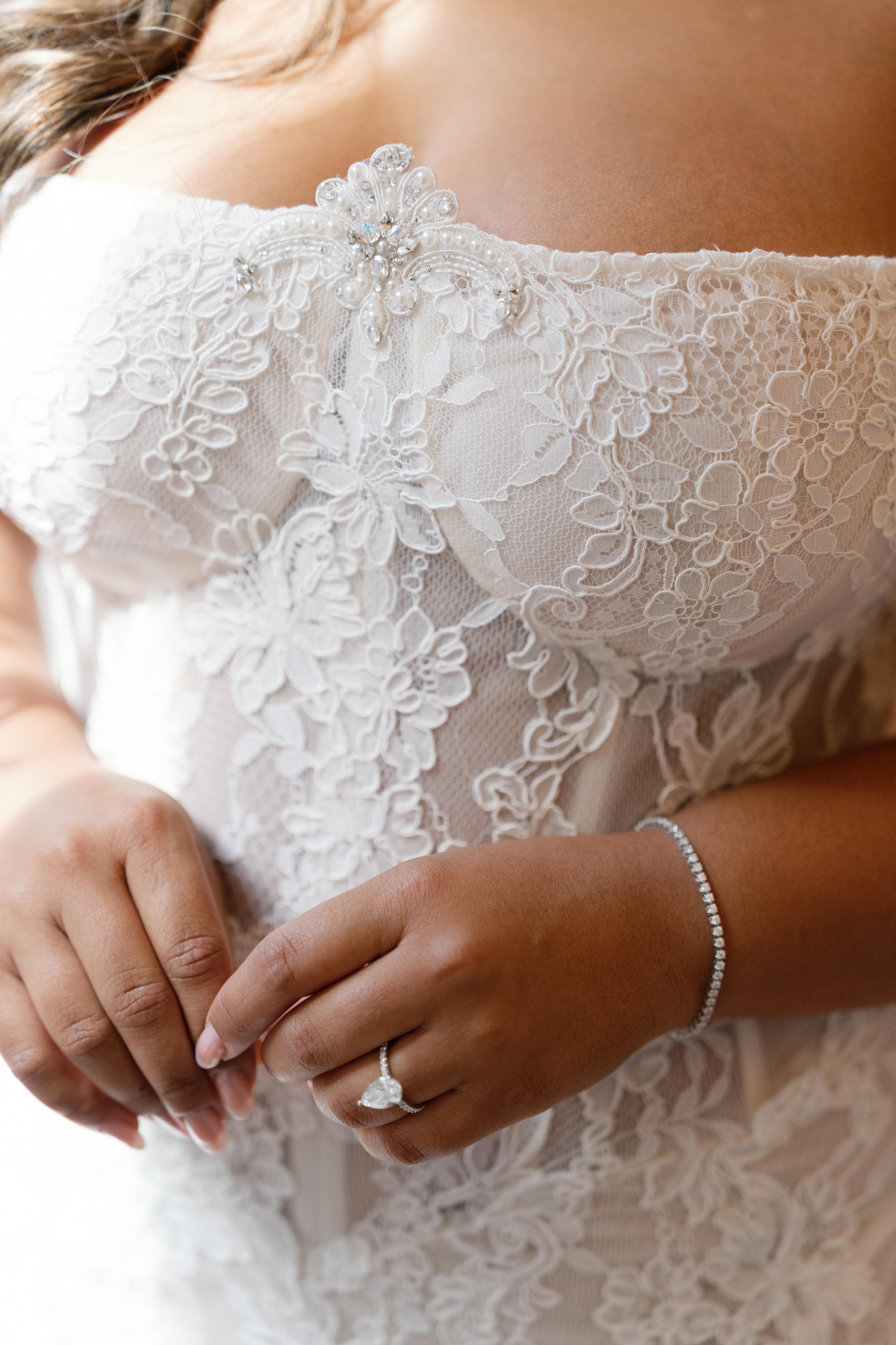 Close-up of GL Bride Janai in our Anais with her wedding ring on her finger.