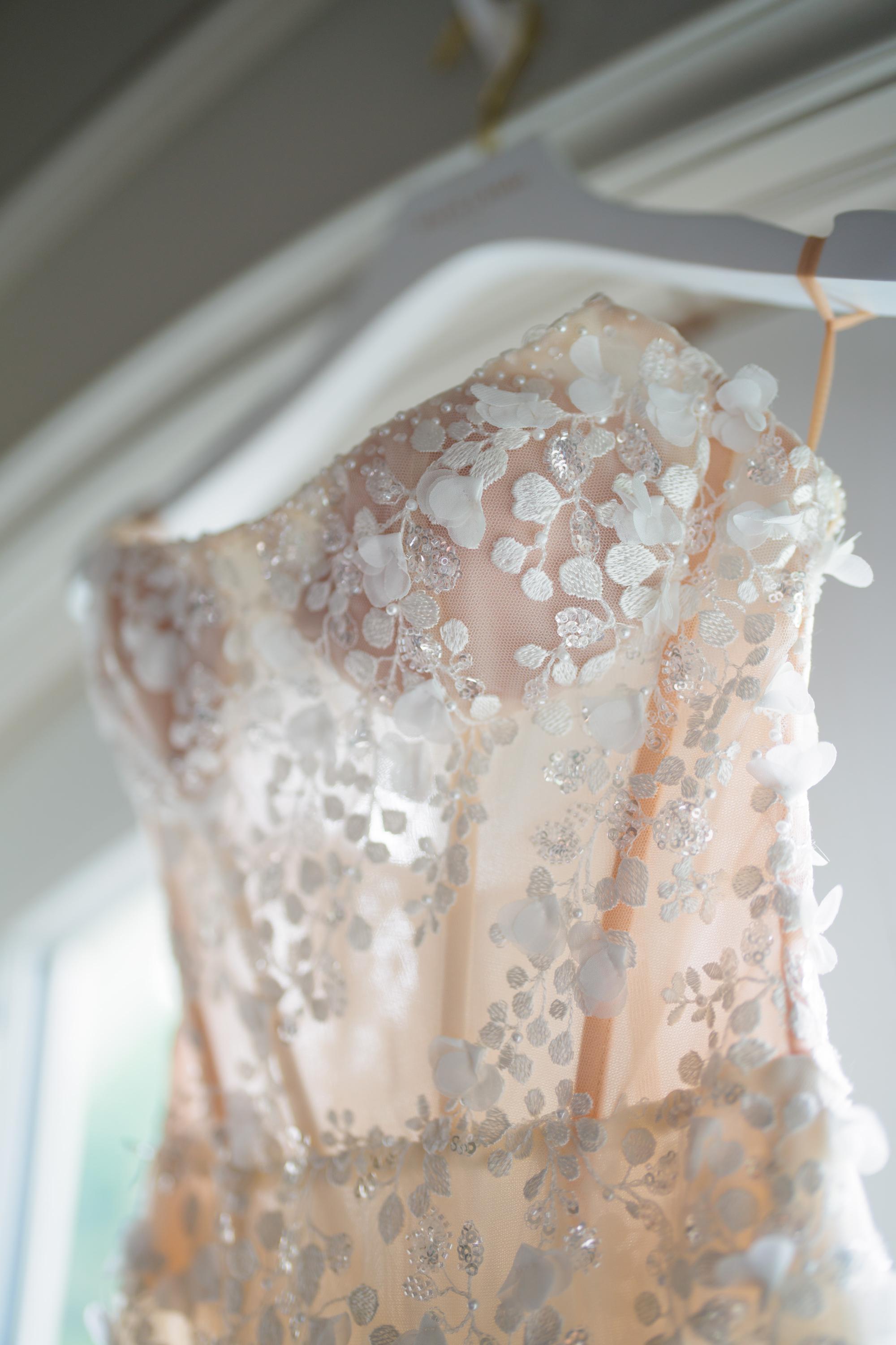 Galia Lahav's Catalina Gown on a hanger against a neutral background