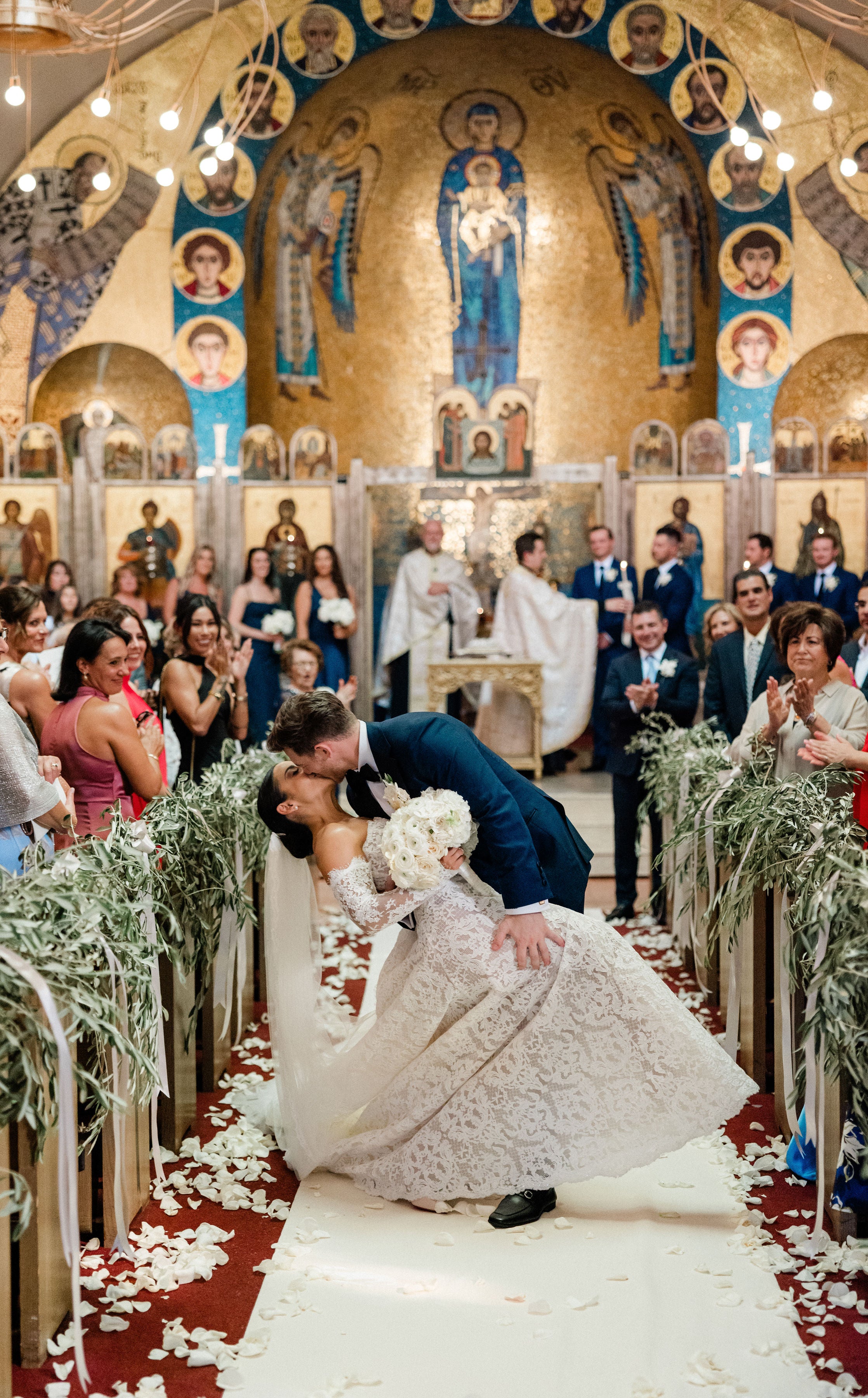 GL Bride Megan wearing Galia Lahav Splendid at her wedding ceremony in a church with a decorated altar, floral aisle and guests.