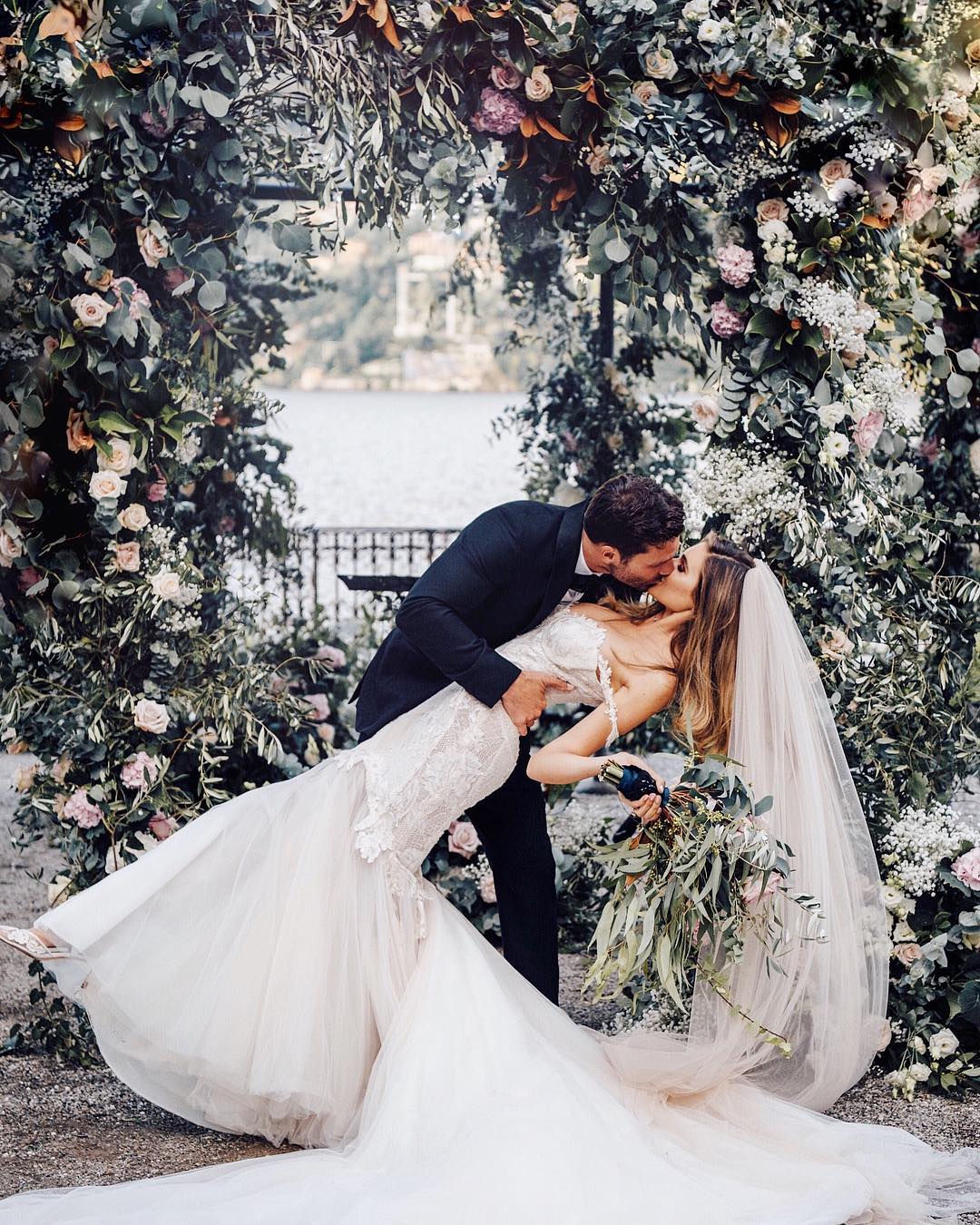 GL Bride Natalie wearing the Tony gown while kissing her groom 