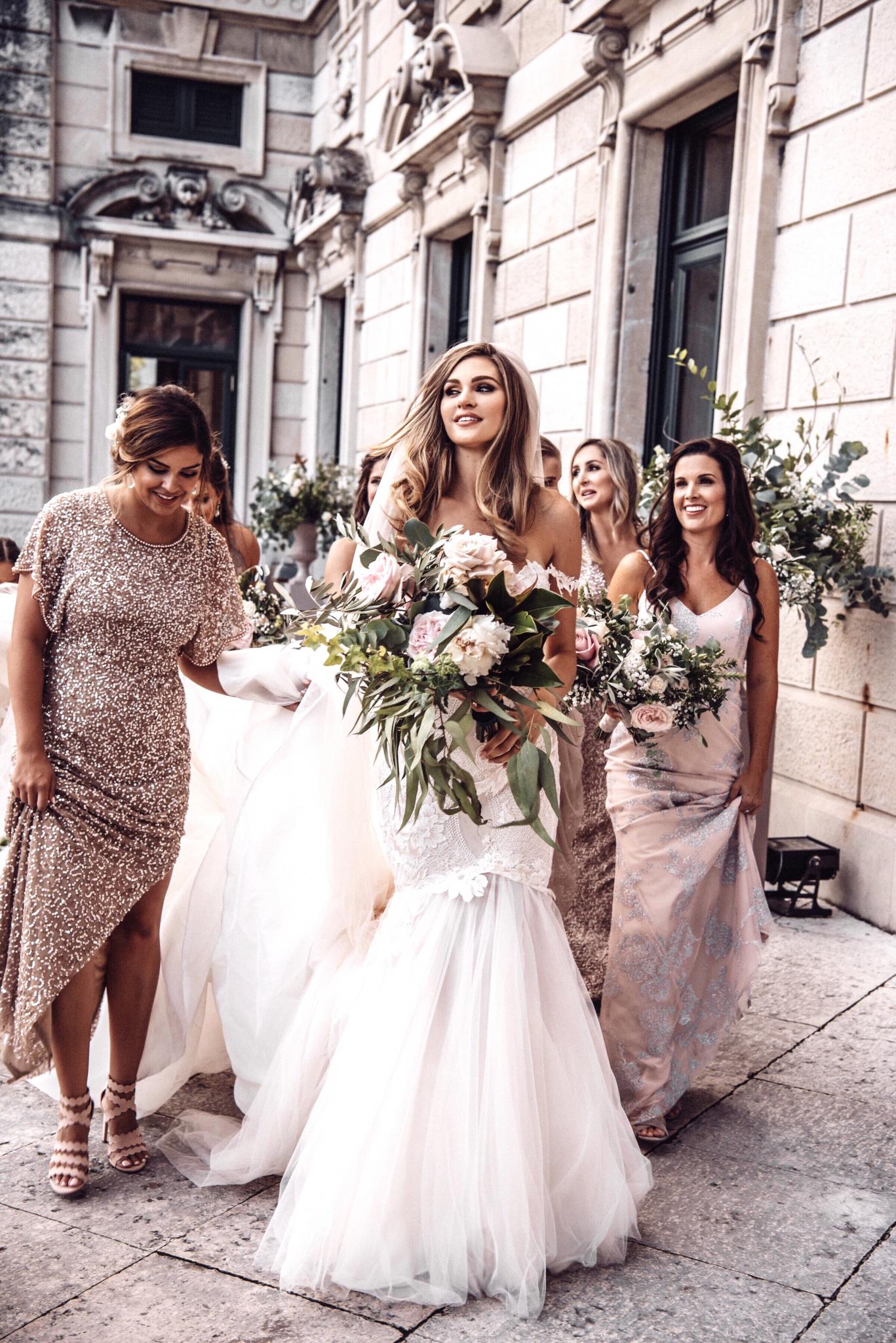 GL Bride Natalie in our Tony gown walking with her bridesmaids