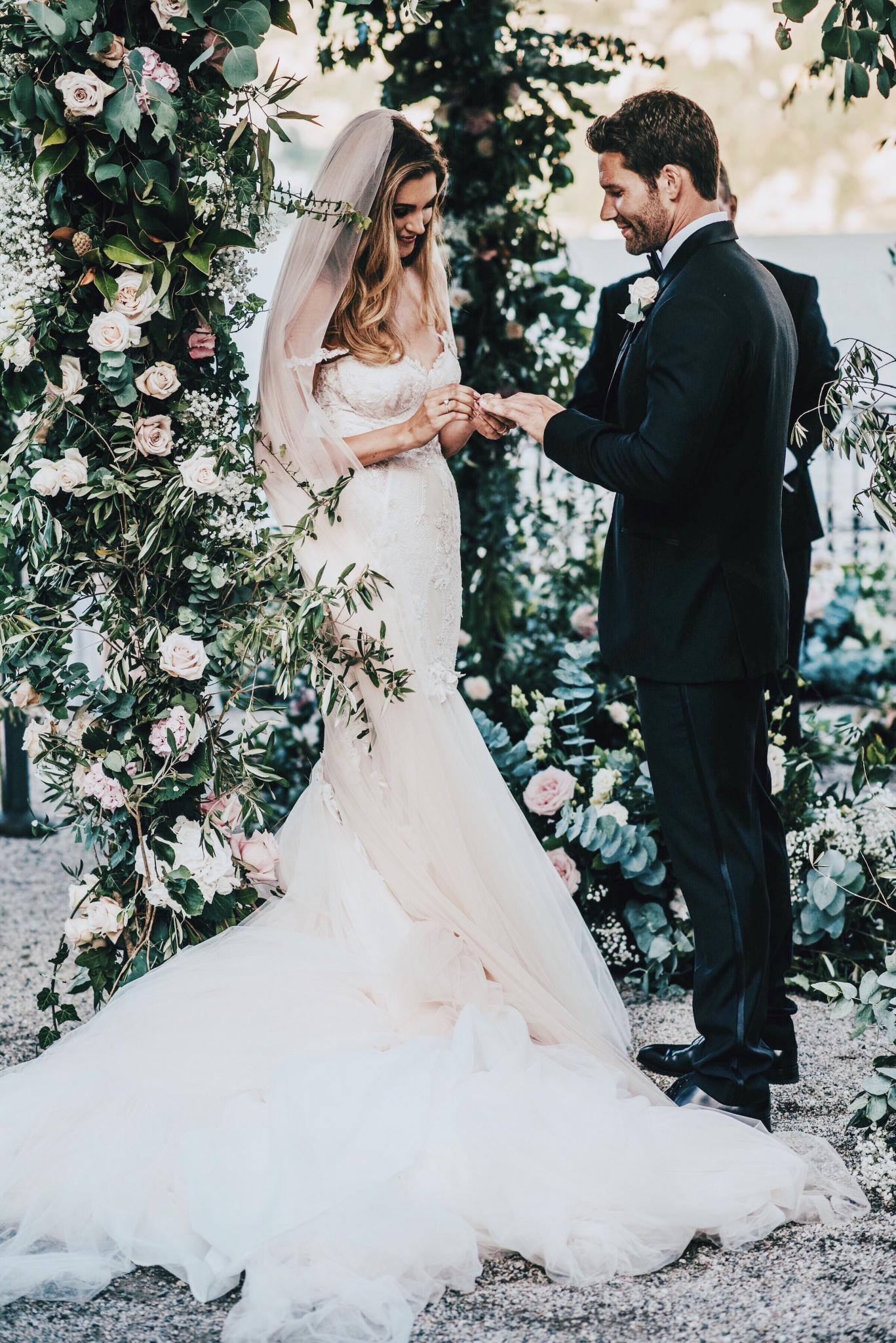 GL Bride Natalie in our Tony gown exchanging vows with her groom 
