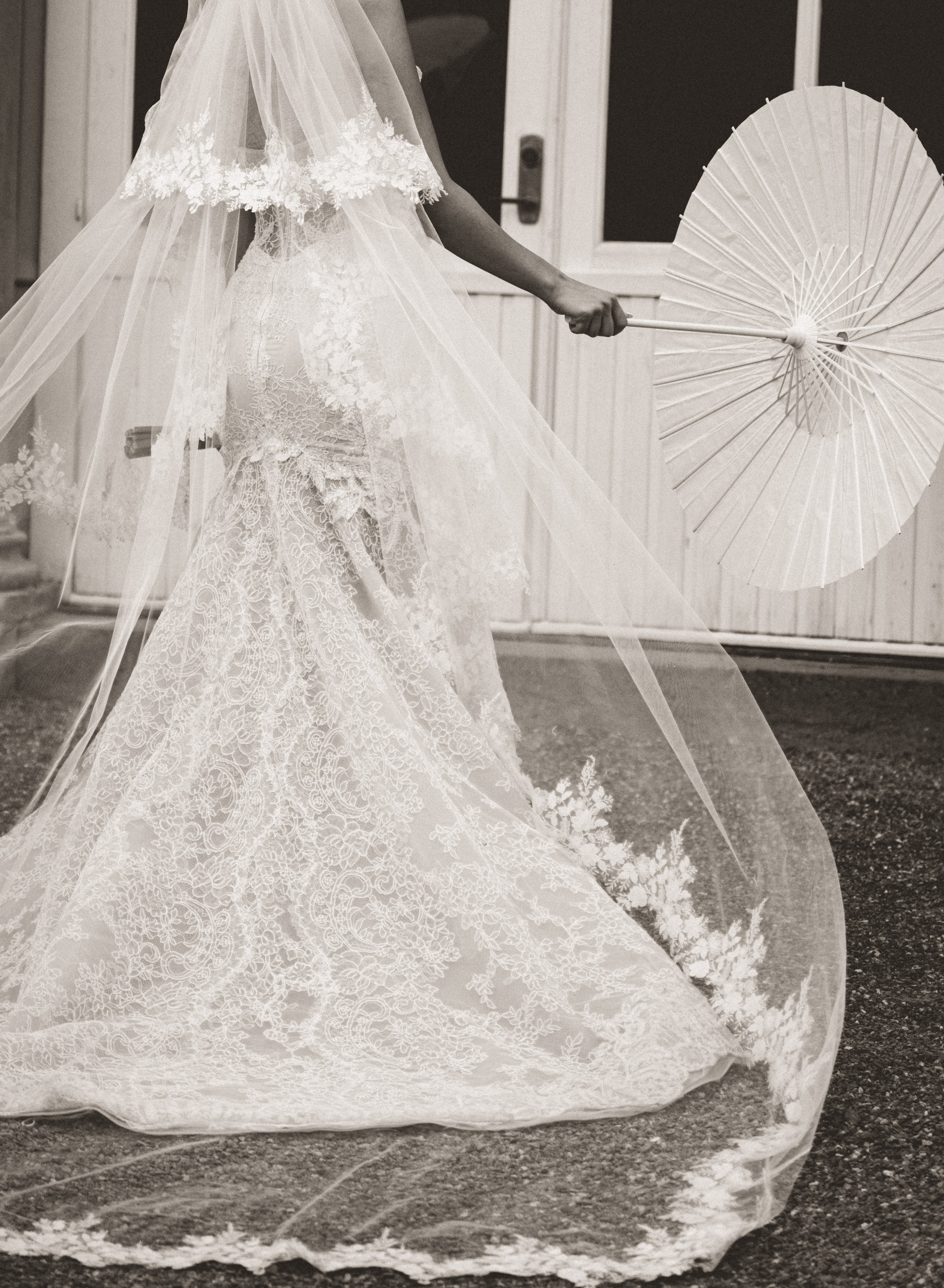 Close-up of the Scarlett wedding dress with a long train and floral details, worn by our GL Bride Rebecca