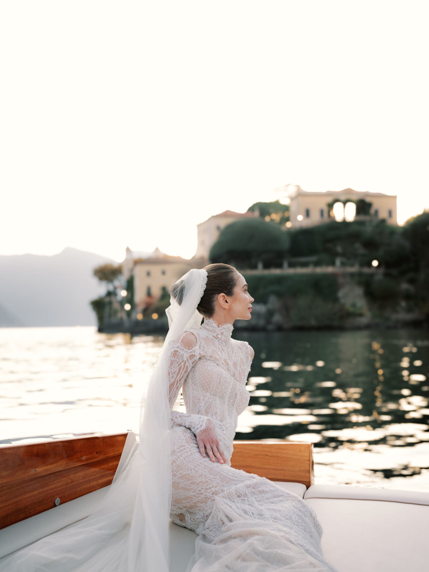 GL Bride Sarah Ingles in Our Élysée in a wedding dress on a boat with a scenic background 