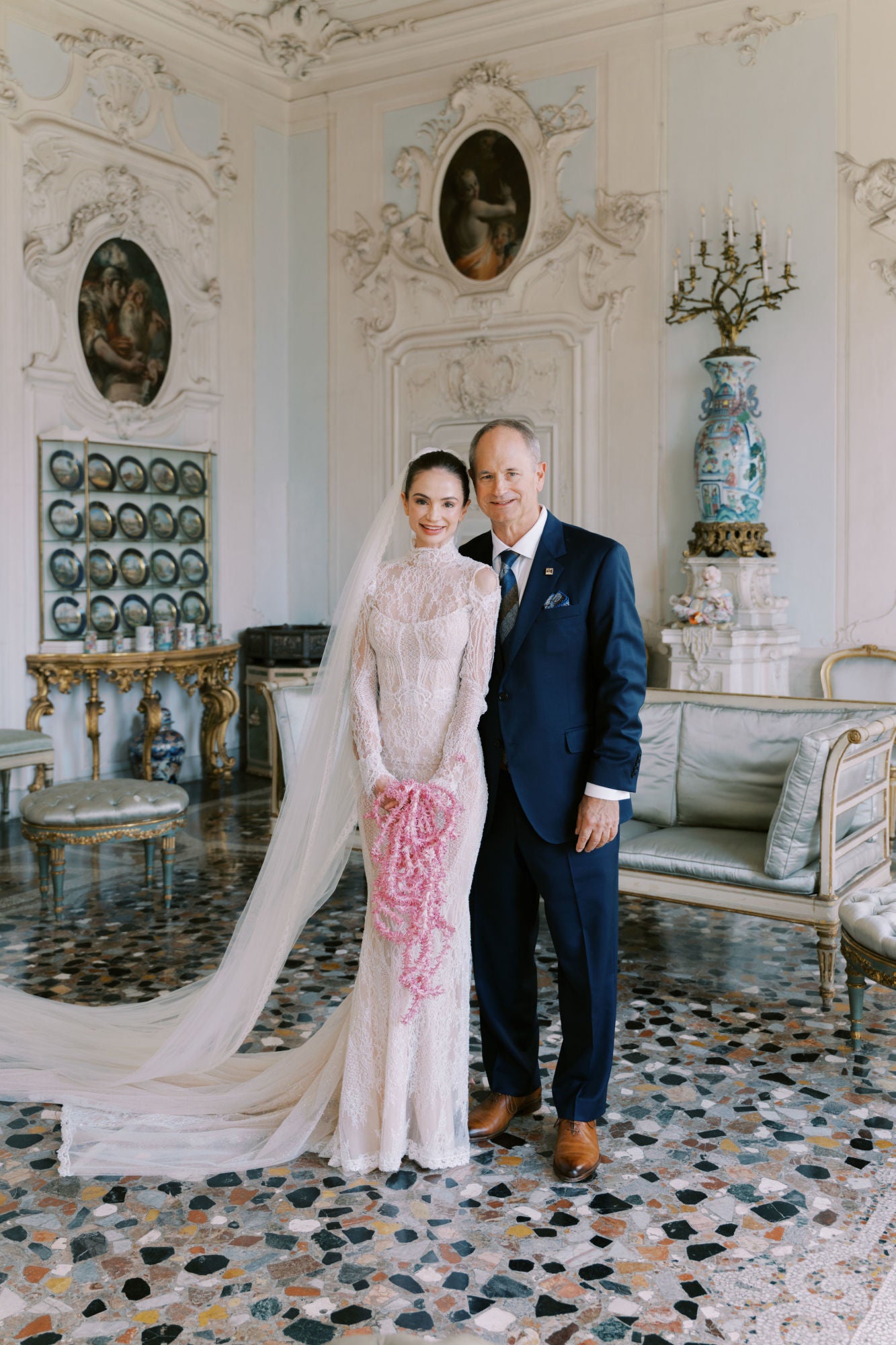 GL Bride Sarah Ingle wearing the Élysée standing in an ornate room with decorative elements.