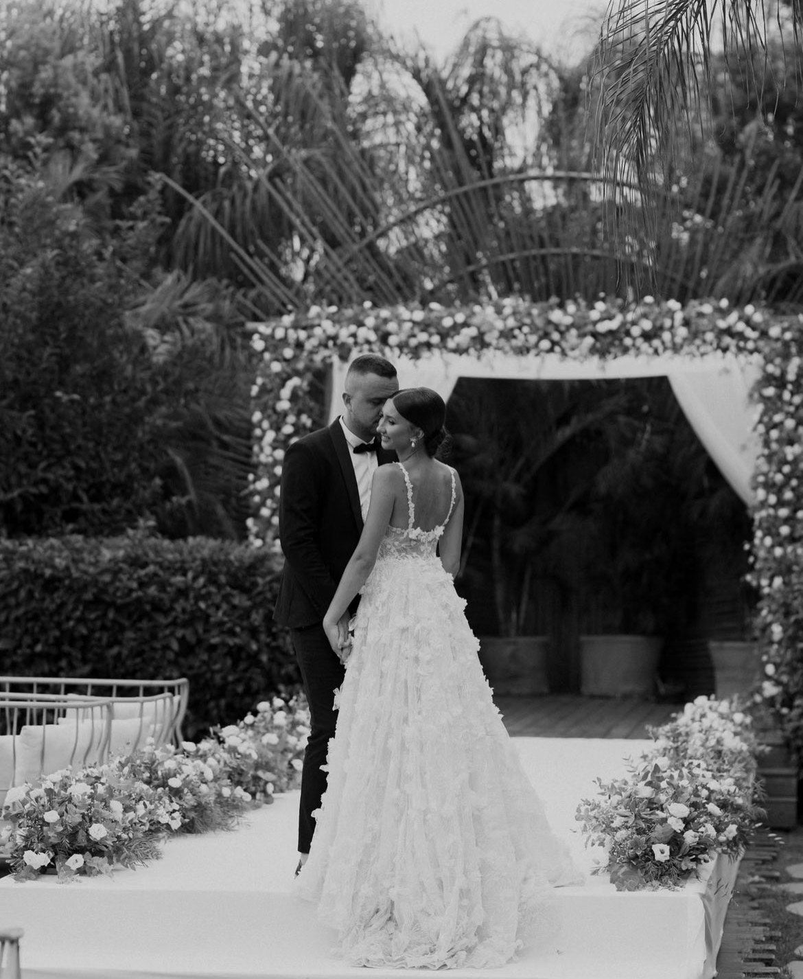 GL Bride Tanya wearing our Fabiana gown standing with her husband