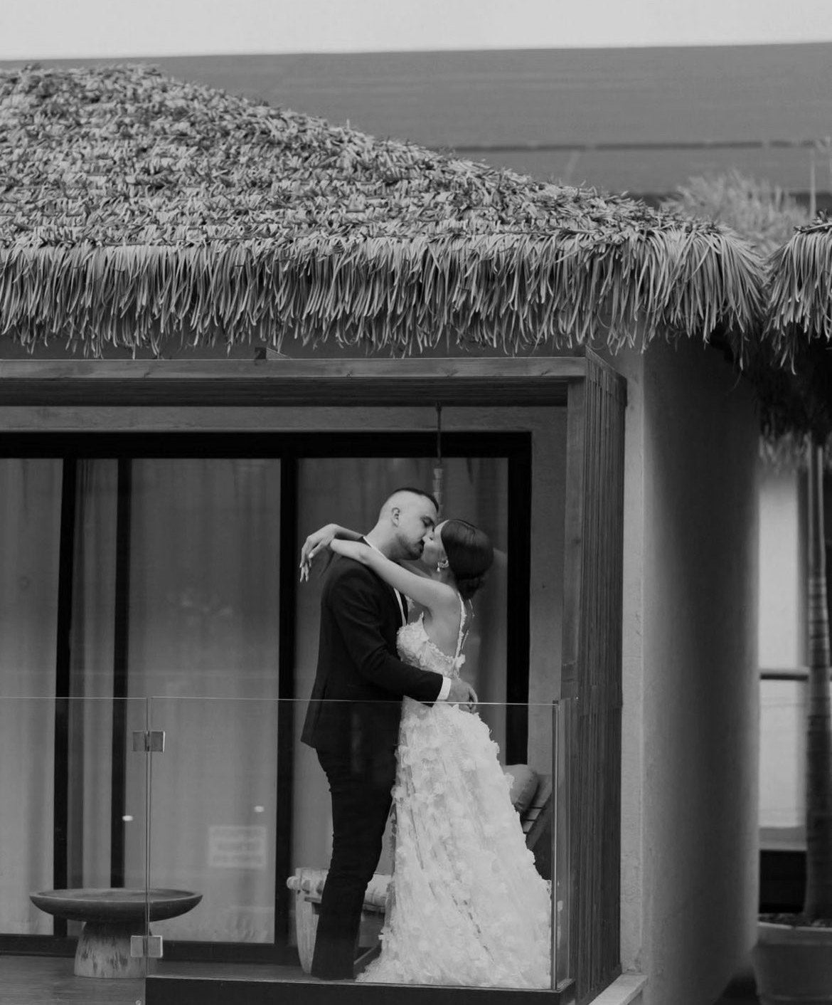 GL Bride Tanya wearing the Fabiana gown, and kissing her husband 