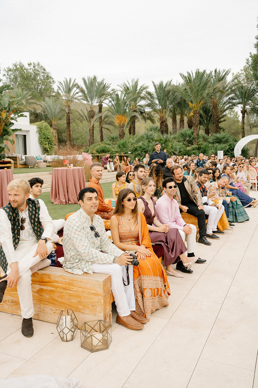 Guest sitting outdoors with palm trees in the background