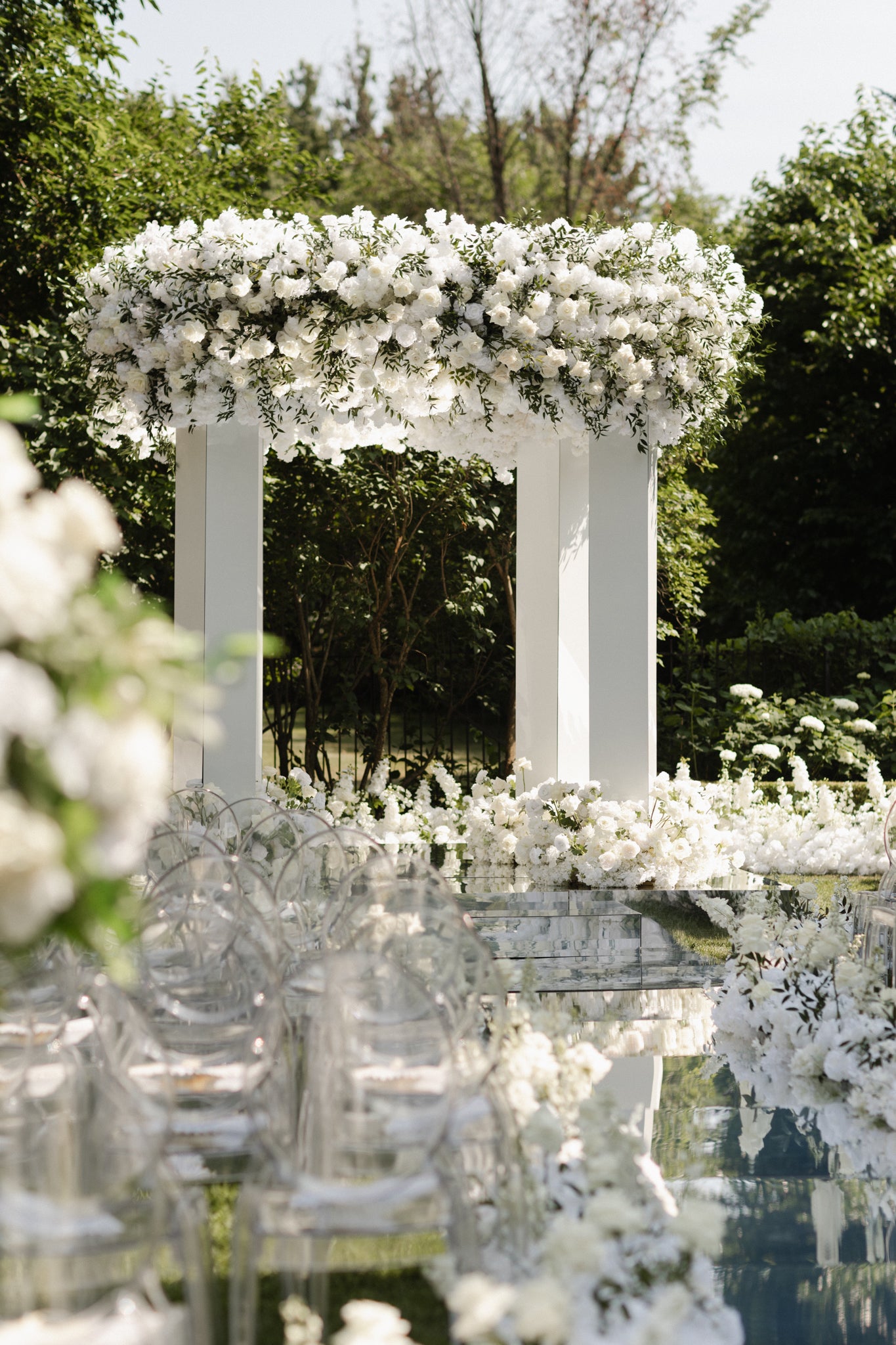 Decorative floral arch with white flowers in an outdoor setting