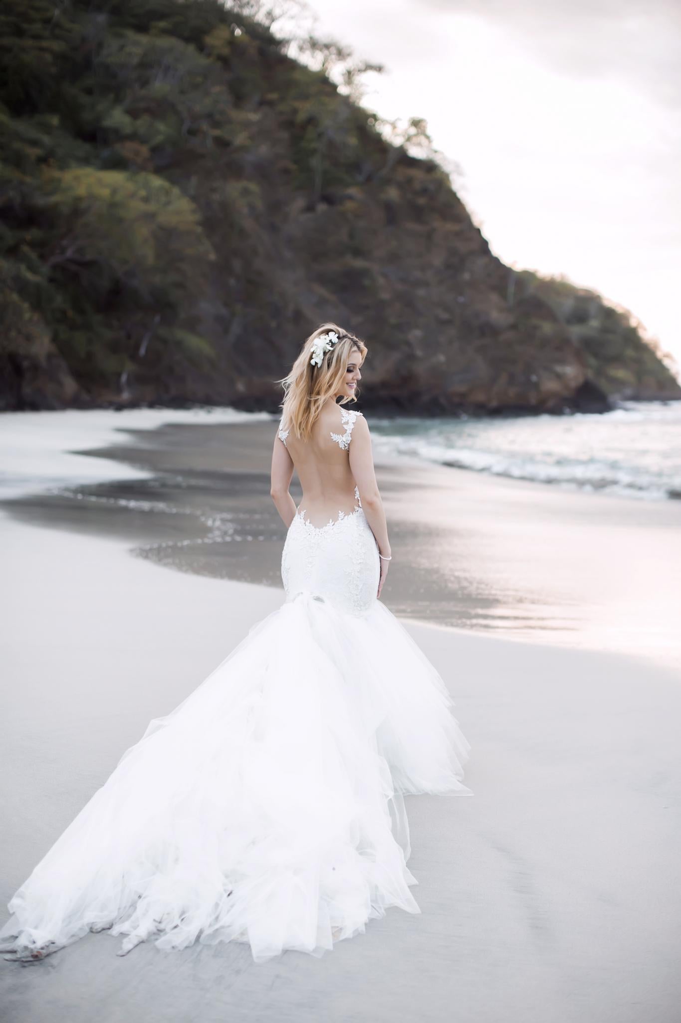 GL Bride Allie wearing our Loretta gown on the beach 