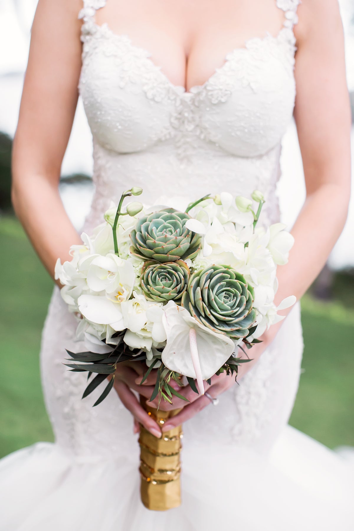 Close up of GL Bride Allie wearing our Loretta gown with her bouquet 