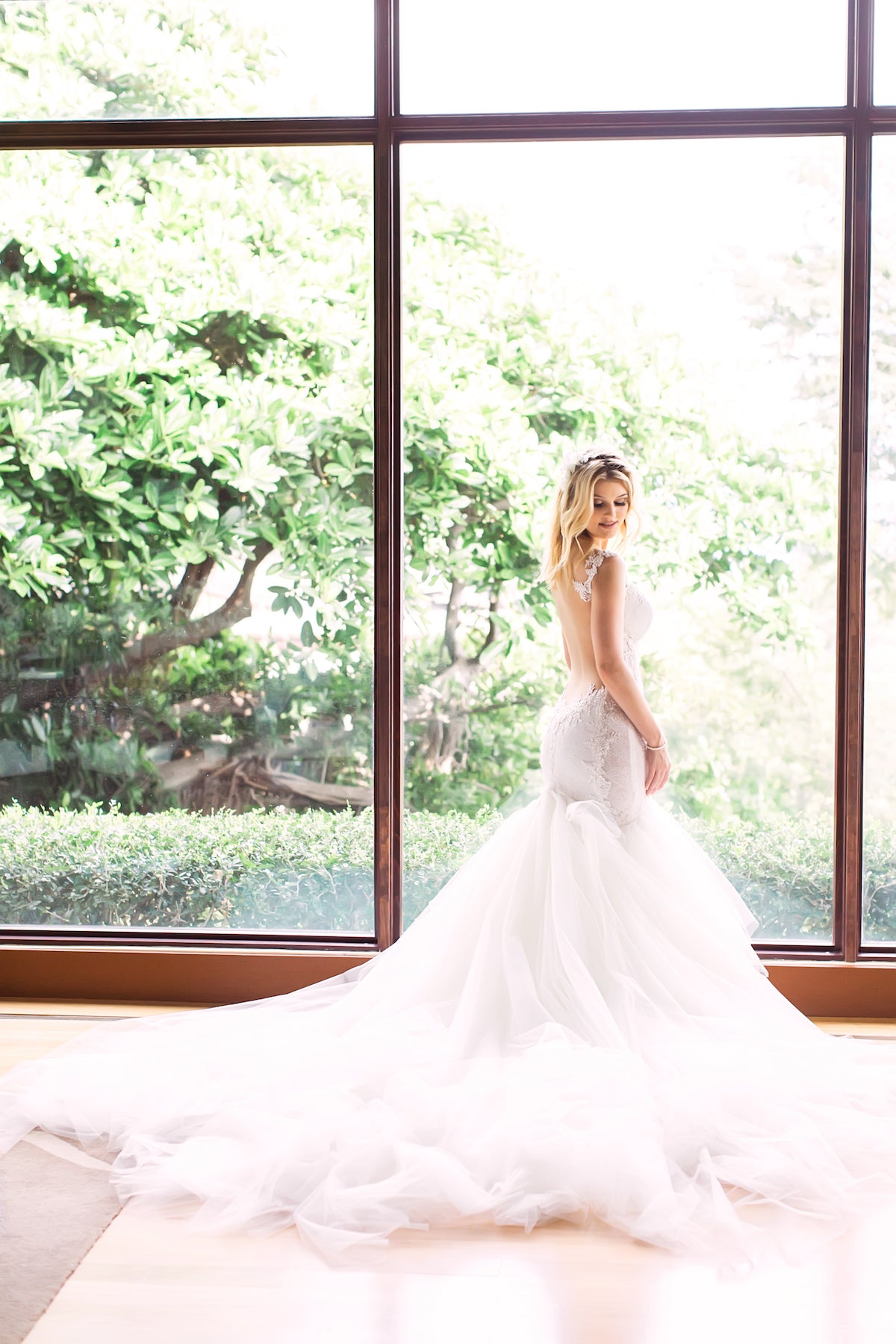 GL Bride Allie wearing our Loretta gown in a window 