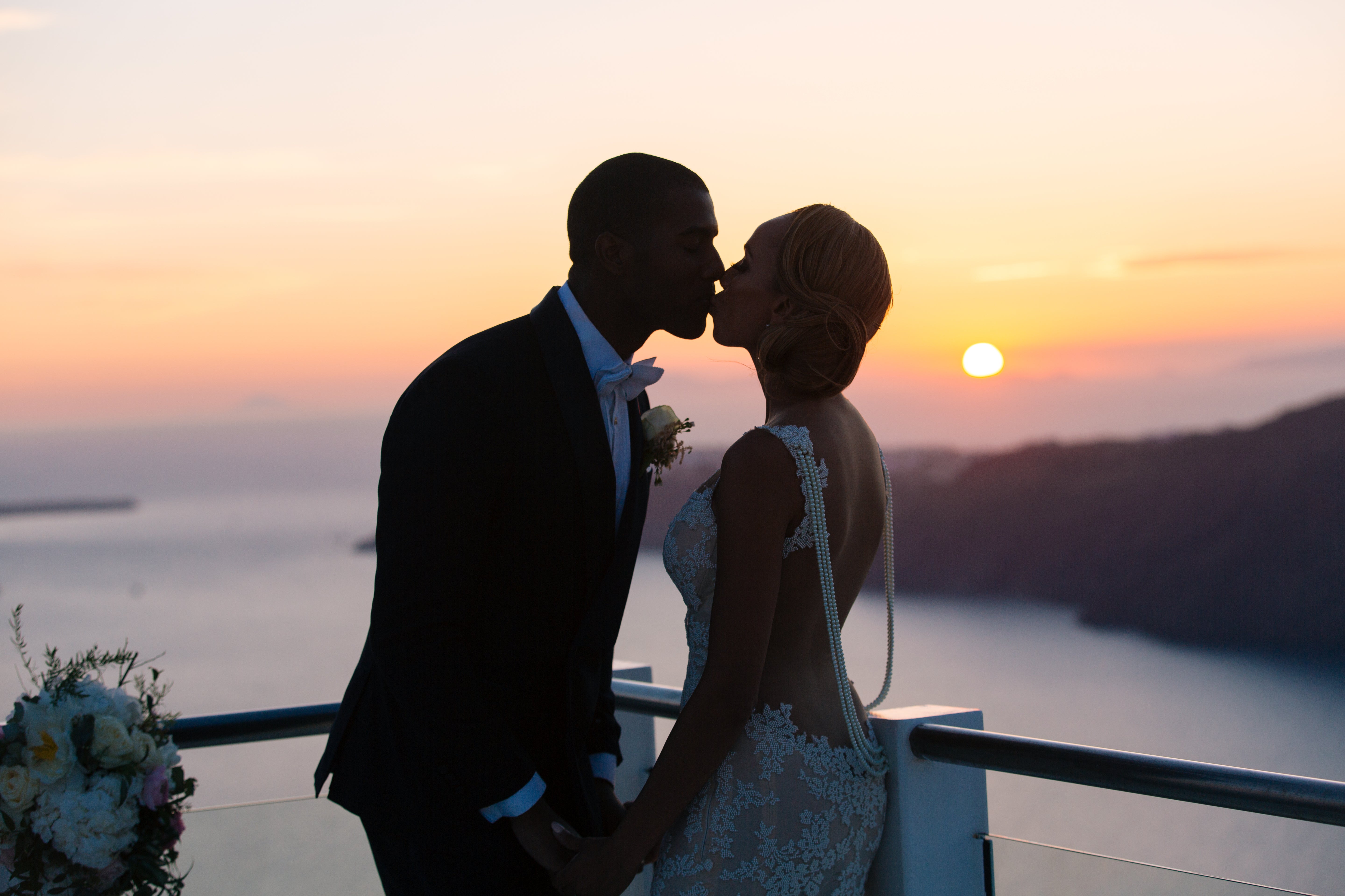 GL Bride Essie wearing Galia Lahav Patchouli  kissing her groom