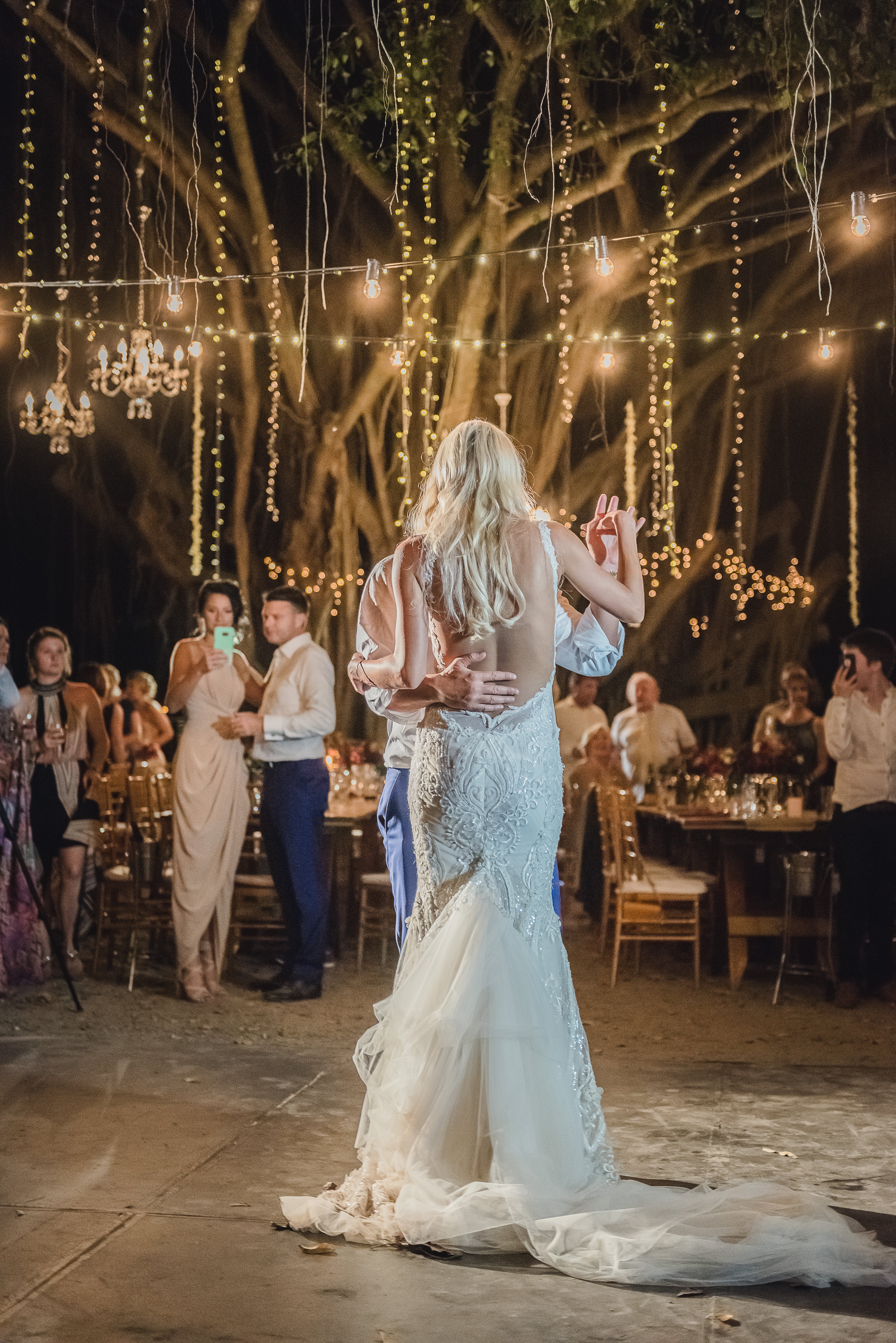 GL Bride Elise wearing our Greta Garbo dancing with her husband under string lights 