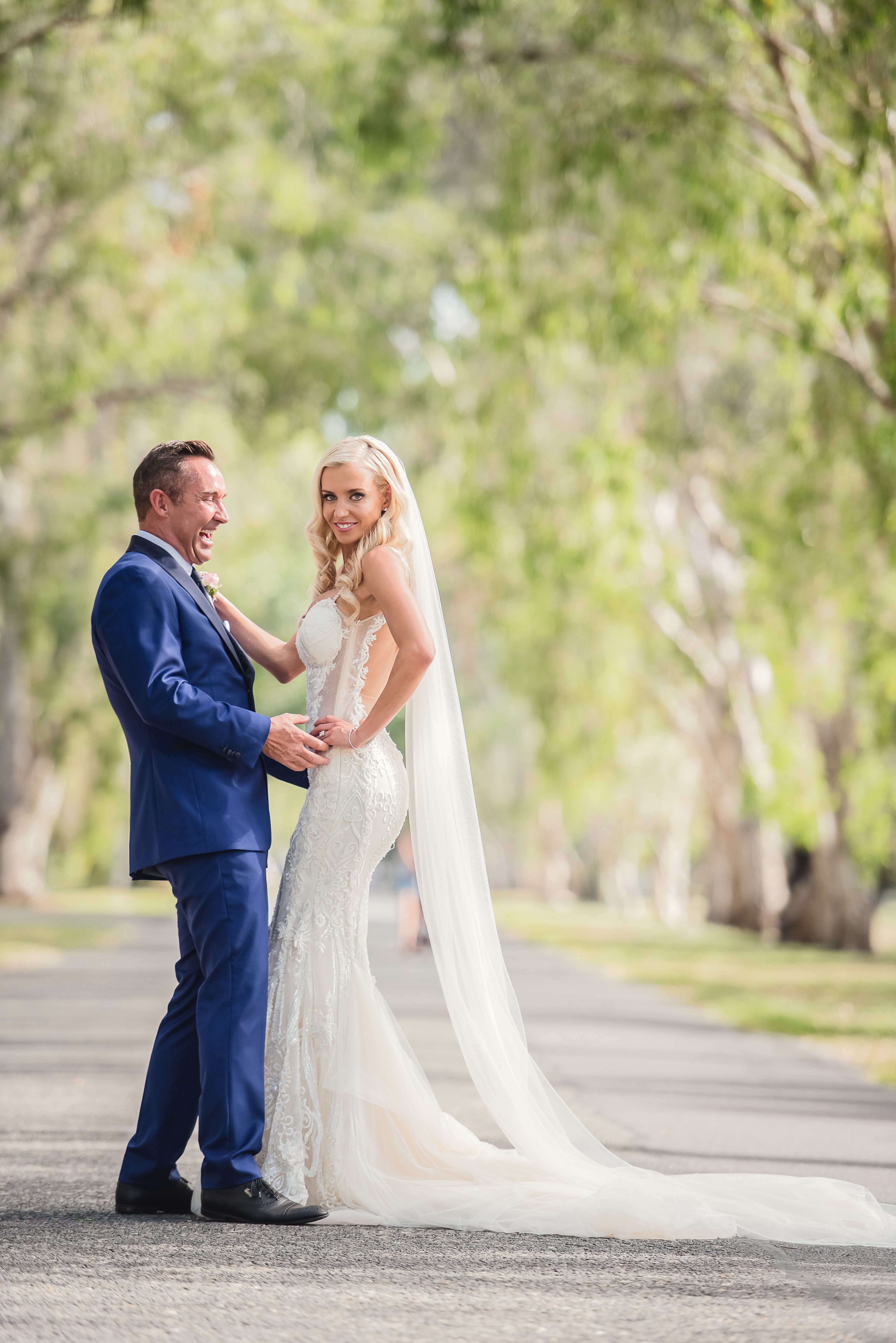 GL Bride Elise wearing our Greta Garbo standing with her husband 
