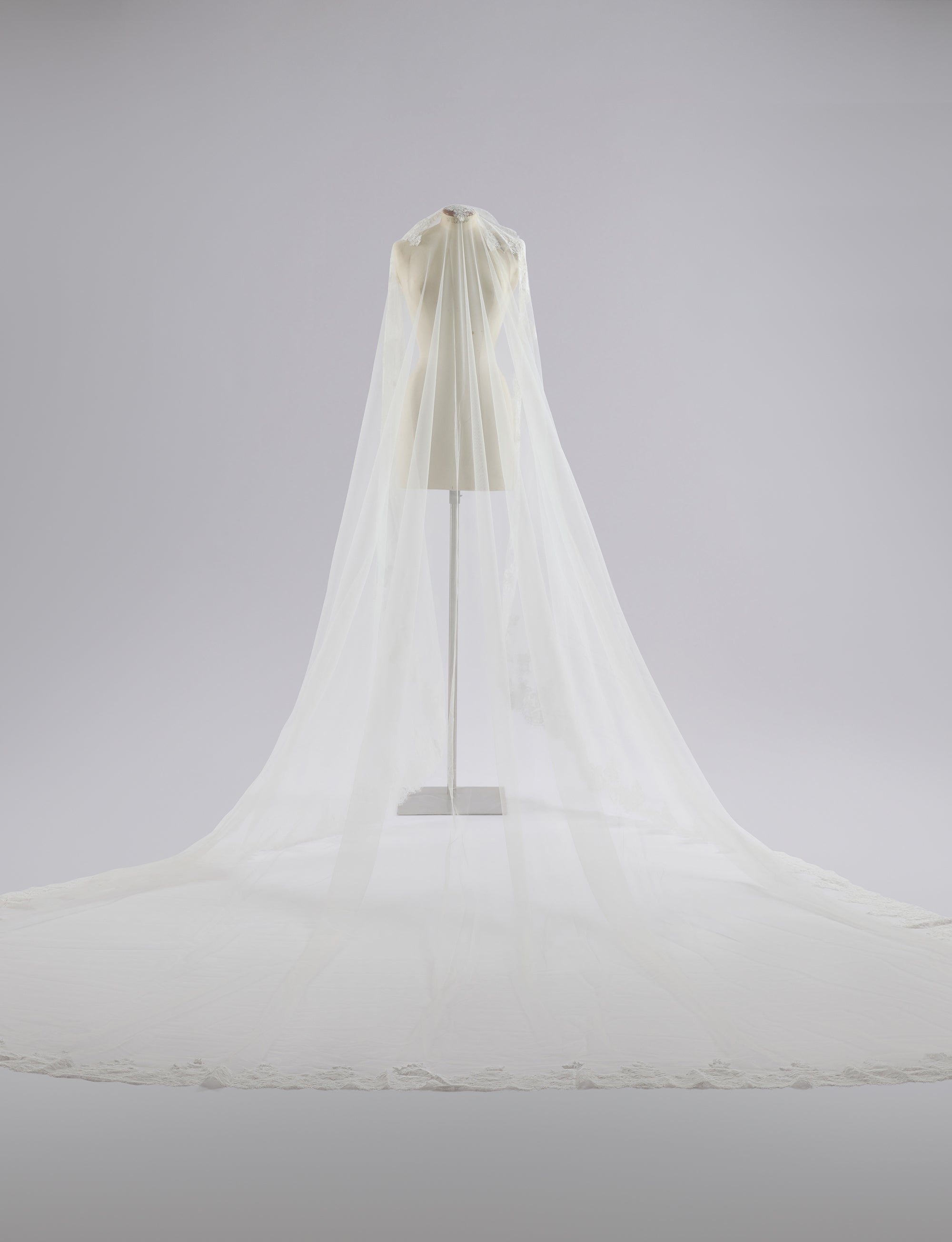 White canopy bed with a light gray background