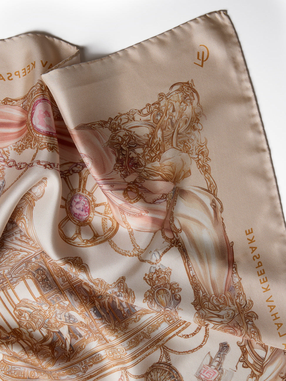 Silk scarf with intricate gold patterns and text on a white background