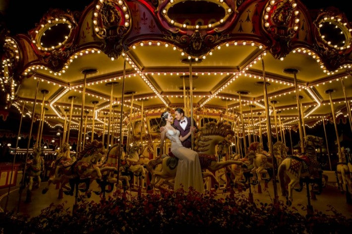 Leanne Li with her groom at a theme park 